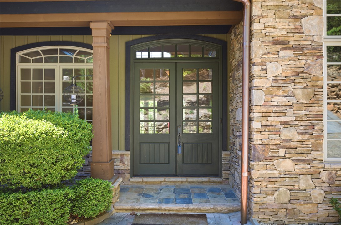 130 River Ridge Road Sunset, SC 29685 - Photo 6 of 47 A welcoming stone and siding facade presents an arched double-door entry with tiled steps.
