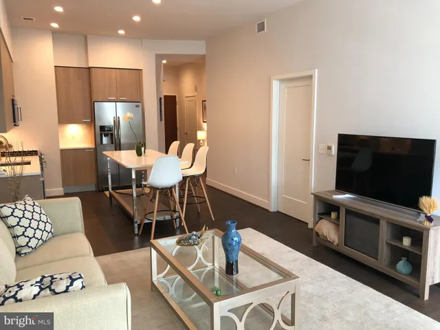 a bedroom with furniture and a large window