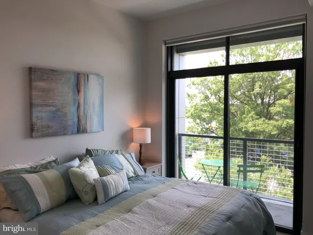 a living room with furniture and a lamp