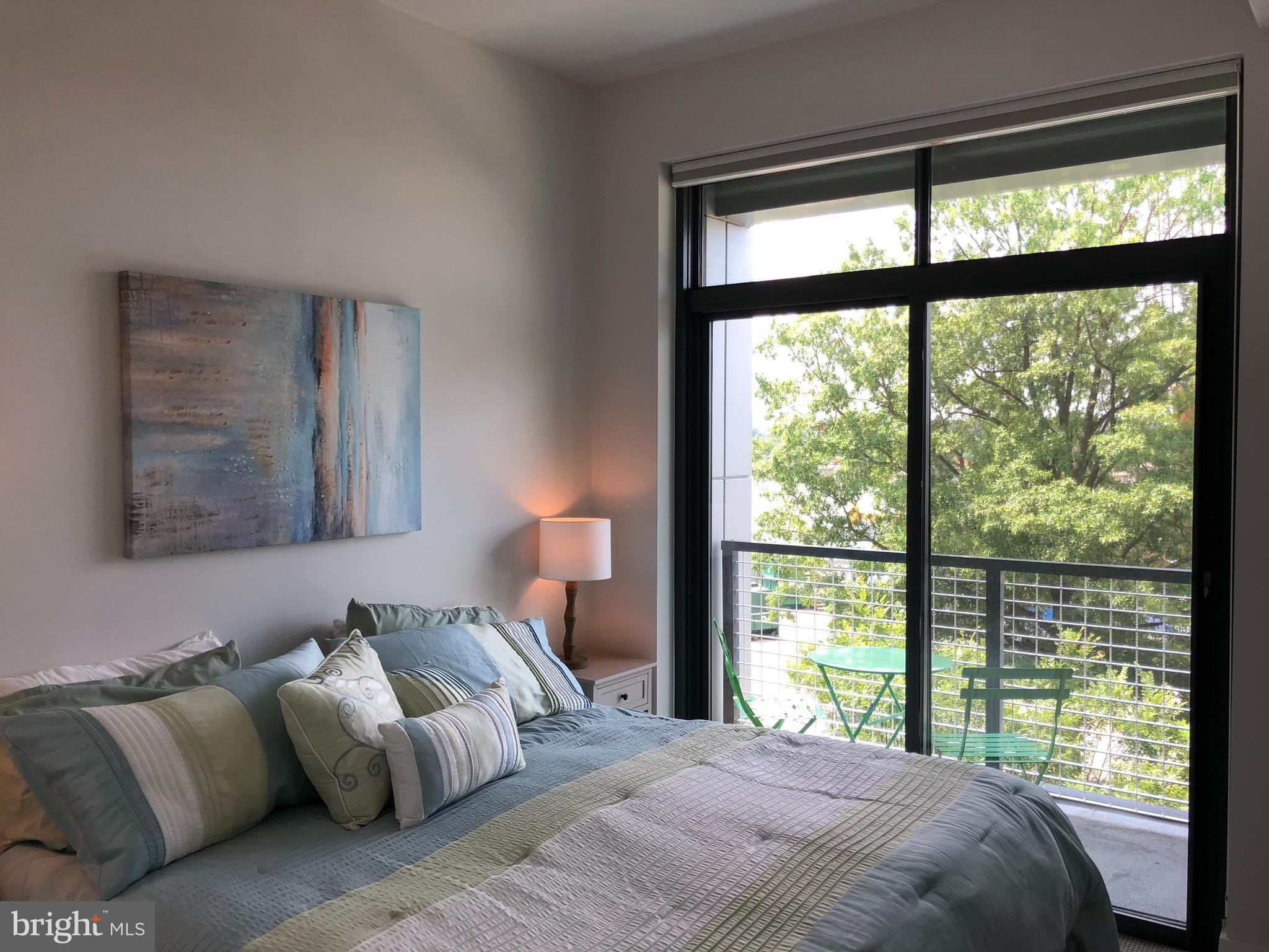 525 Water Street Southwest, Unit 308 Washington, DC 20024 - Photo 15 of 24 a bedroom with furniture and a large window