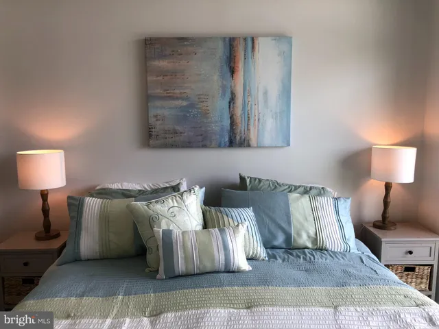 a bedroom with a bed and a mirror