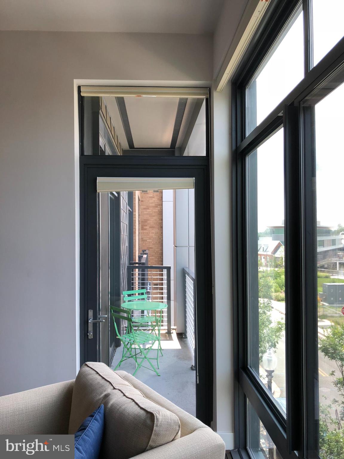 525 Water Street Southwest, Unit 308 Washington, DC 20024 - Photo 19 of 24 a living room with furniture and a floor to ceiling window