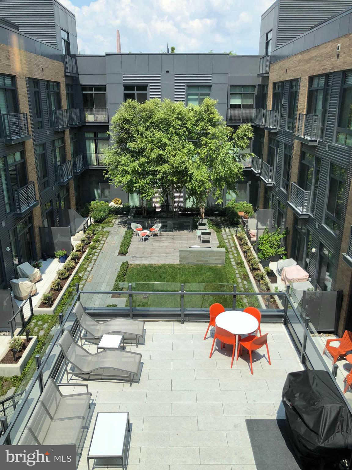 525 Water Street Southwest, Unit 308 Washington, DC 20024 - Photo 3 of 24 a backyard of a house with outdoor seating