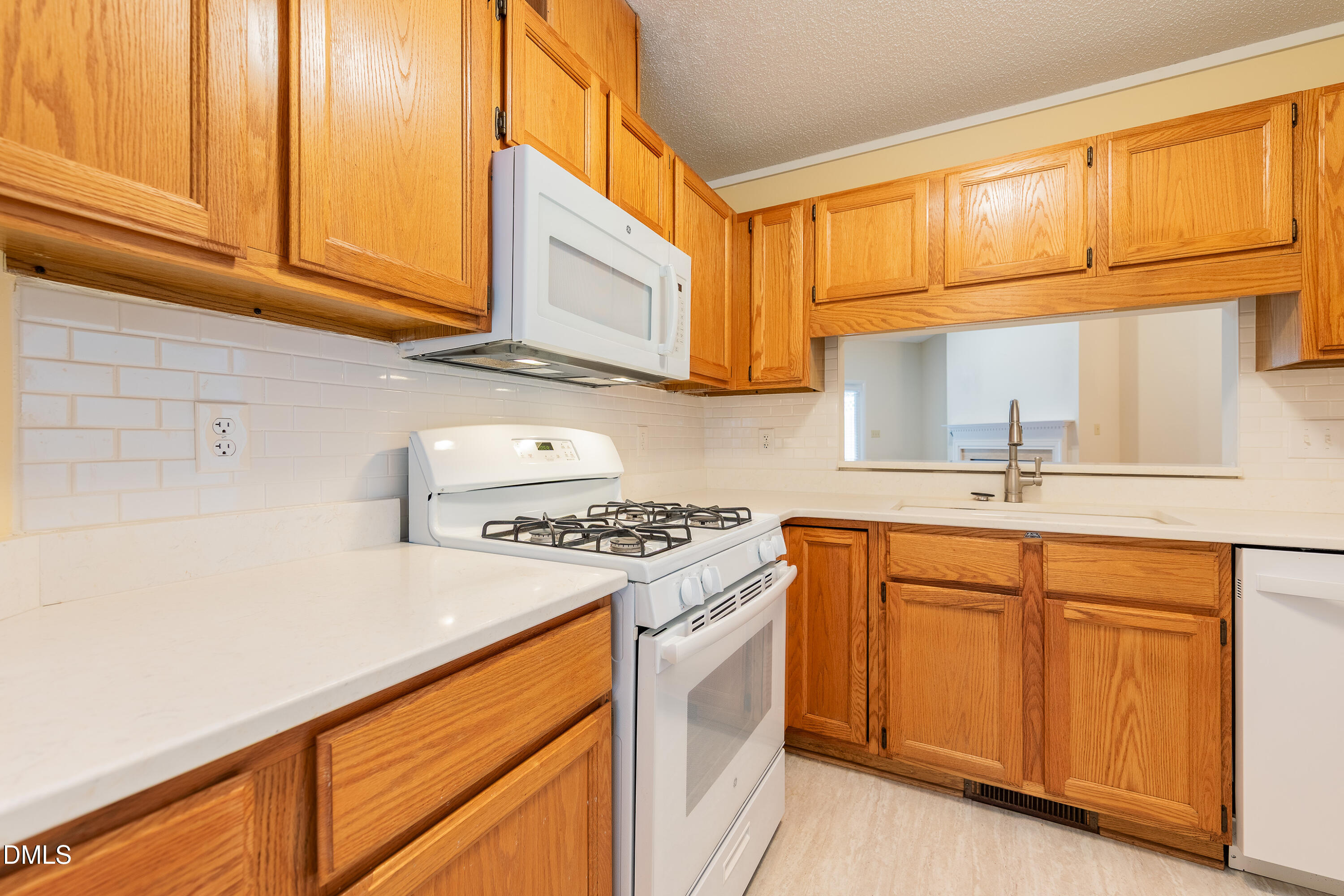 7918 Wood Cove Court Raleigh, NC 27615 - Photo 10 of 31 a kitchen with stainless steel appliances granite countertop a sink stove and cabinets