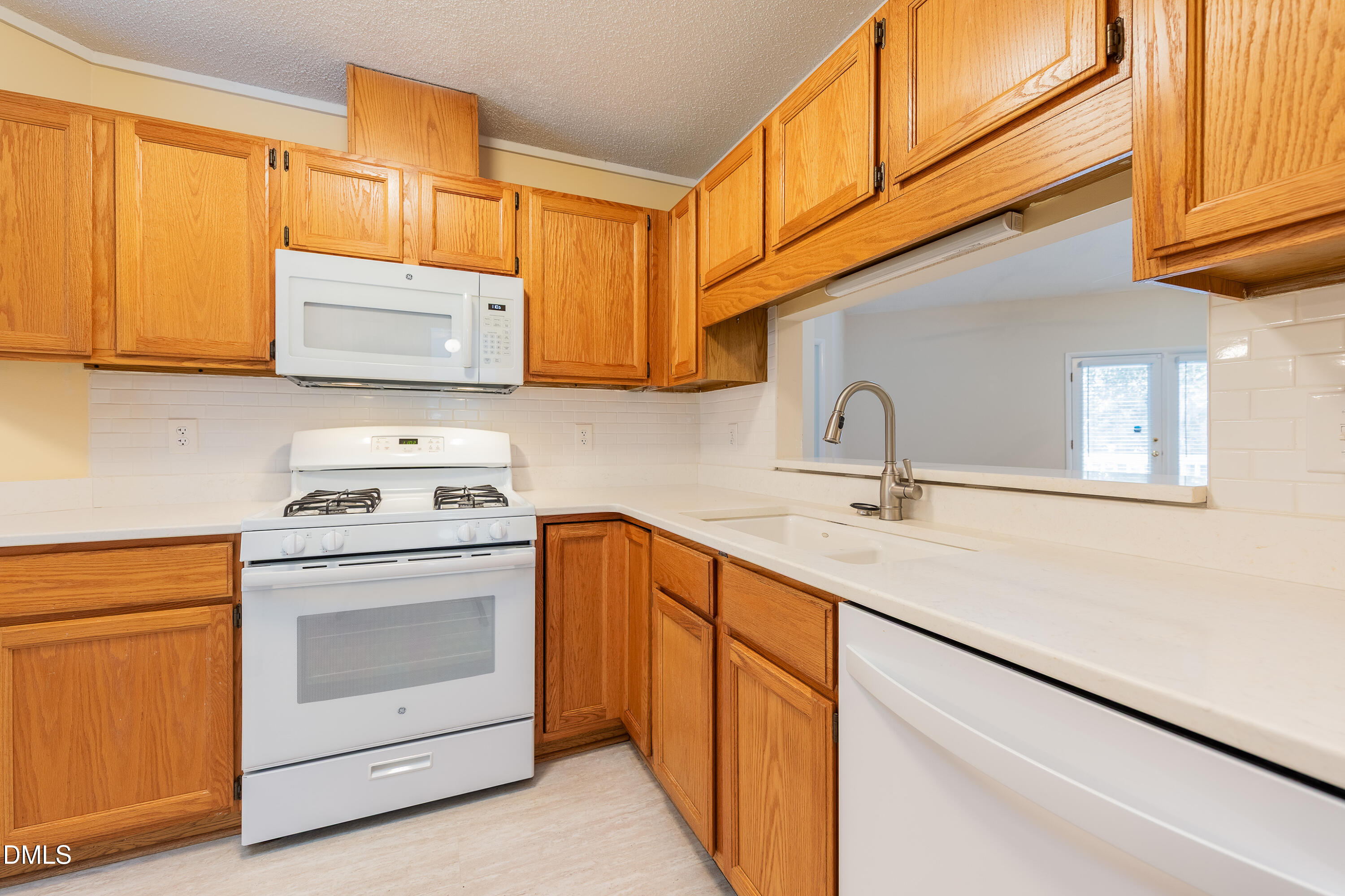 7918 Wood Cove Court Raleigh, NC 27615 - Photo 12 of 31 a kitchen with stainless steel appliances granite countertop a sink and a stove