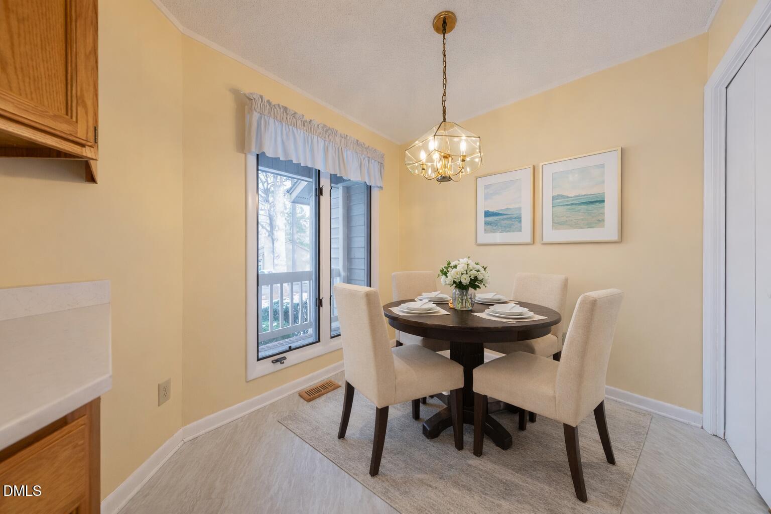 7918 Wood Cove Court Raleigh, NC 27615 - Photo 13 of 31 a view of a dining room with furniture and window