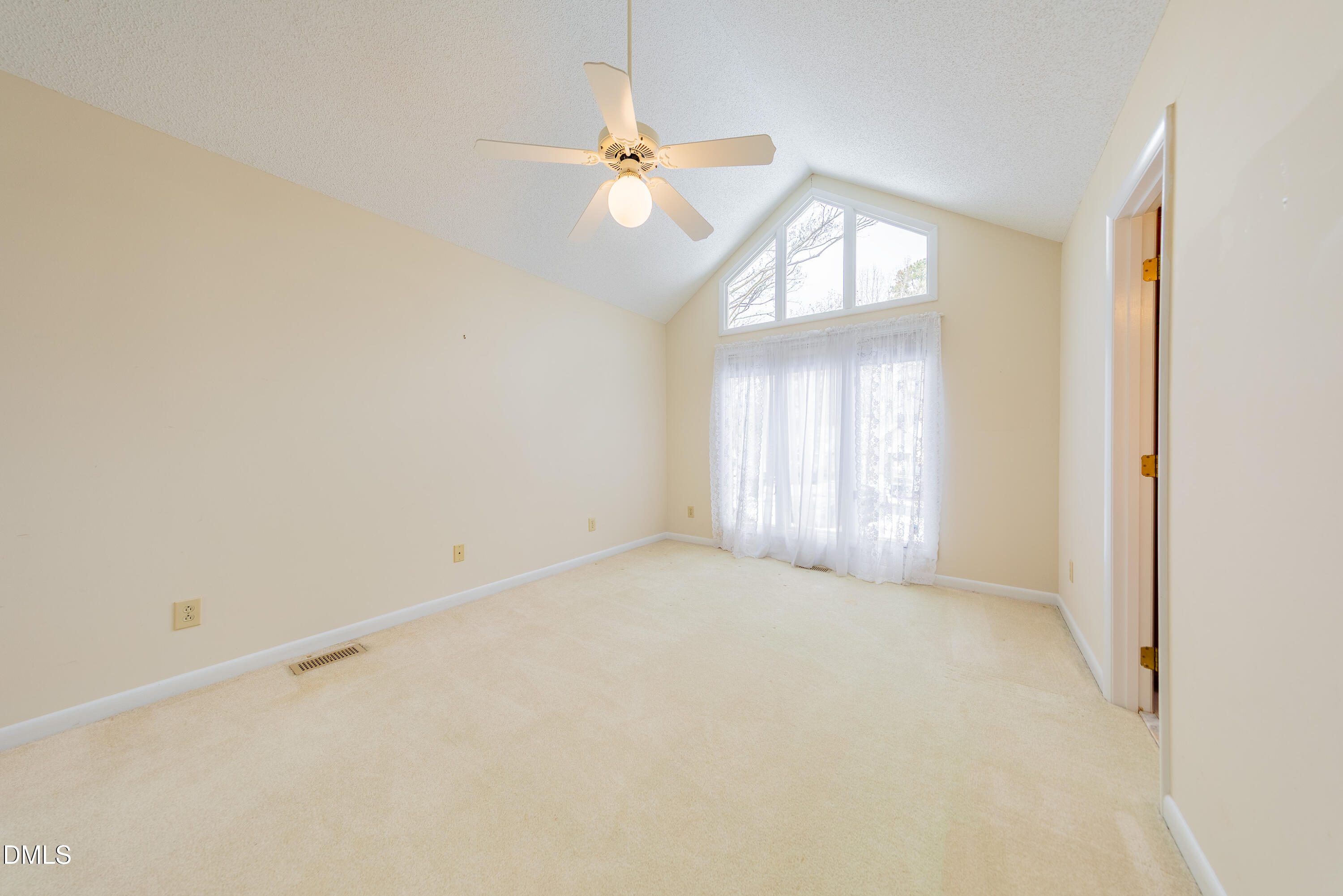 7918 Wood Cove Court Raleigh, NC 27615 - Photo 22 of 31 an empty room with a window and a chandelier