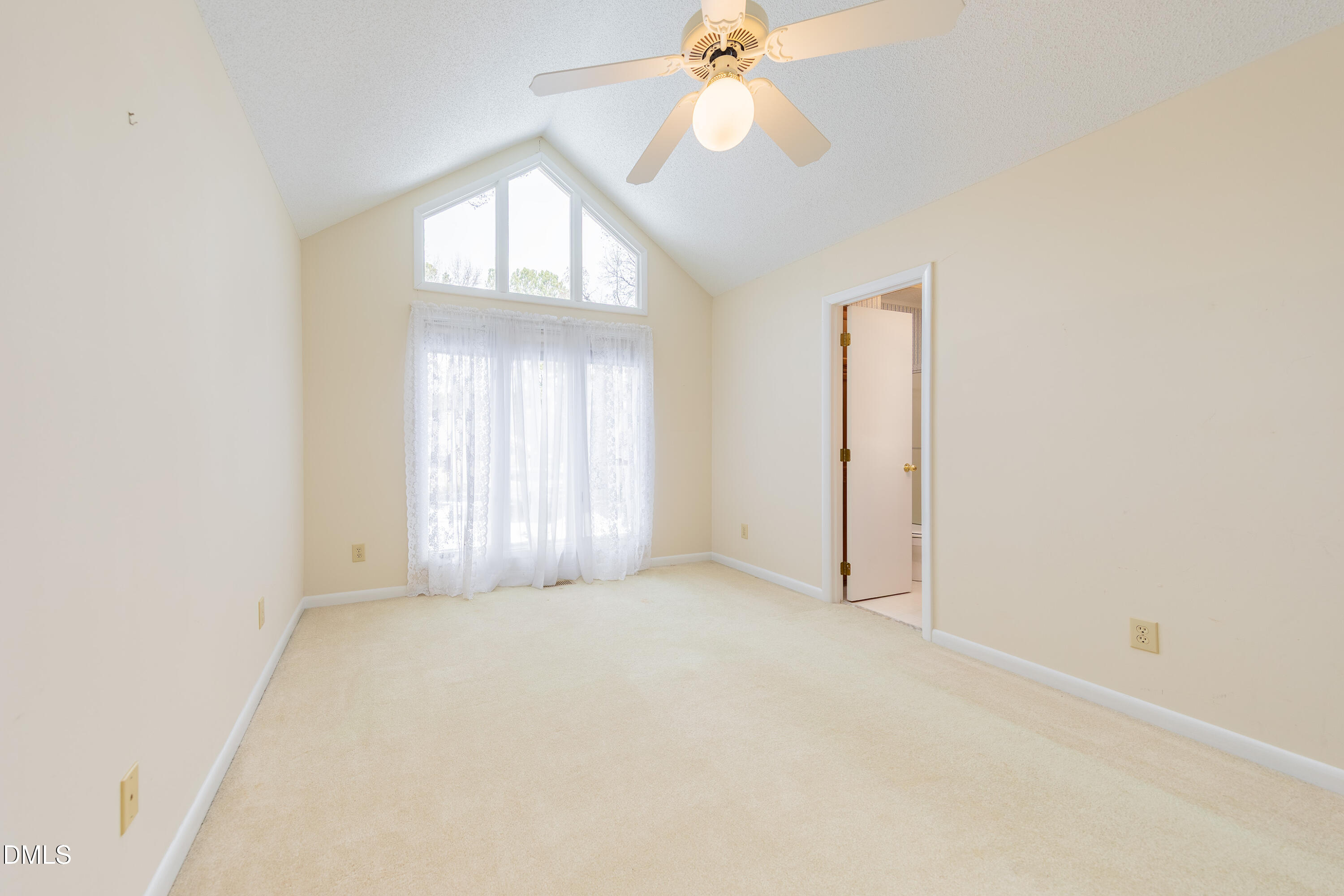 7918 Wood Cove Court Raleigh, NC 27615 - Photo 23 of 31 an empty room with a chandelier fan and windows