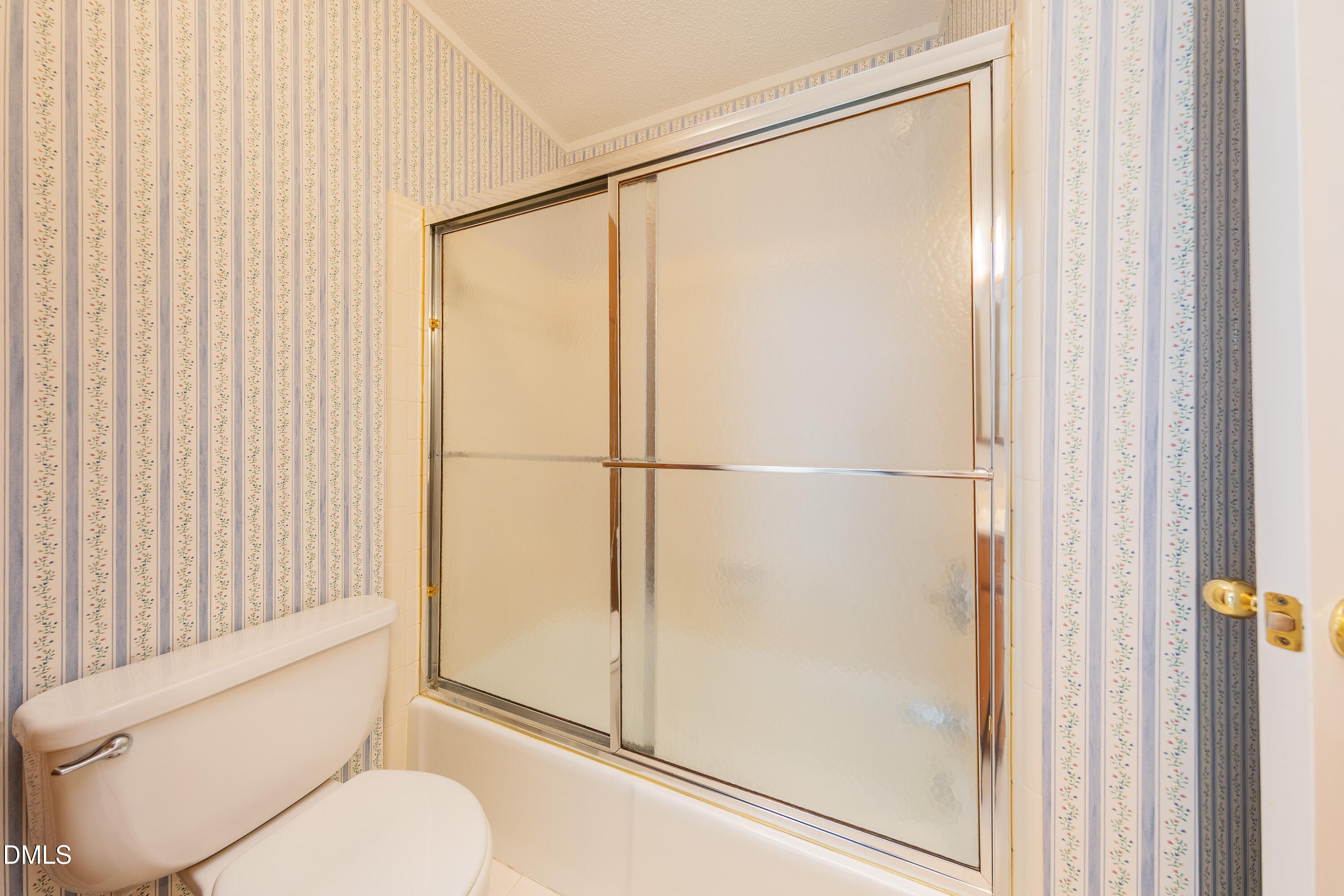 7918 Wood Cove Court Raleigh, NC 27615 - Photo 25 of 31 a bathroom with a toilet and a shower