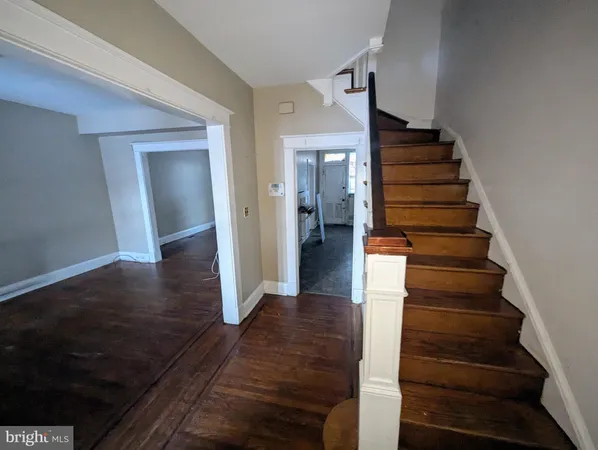 a view of a hallway with wooden floor and entryway
