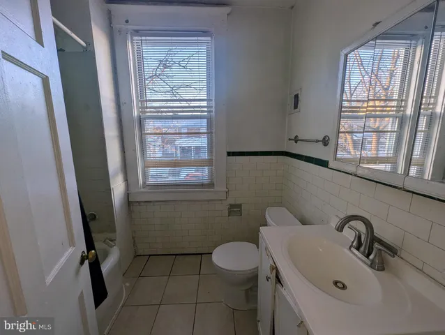 a bathroom with a sink toilet and tub