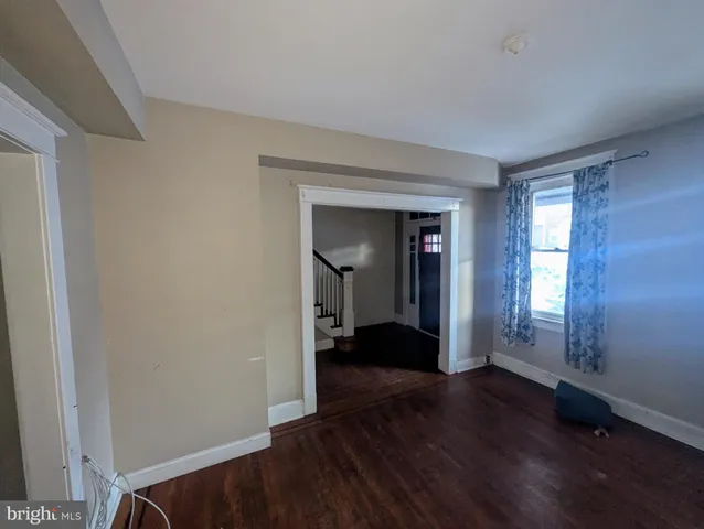 a view of a room with wooden floor and a window