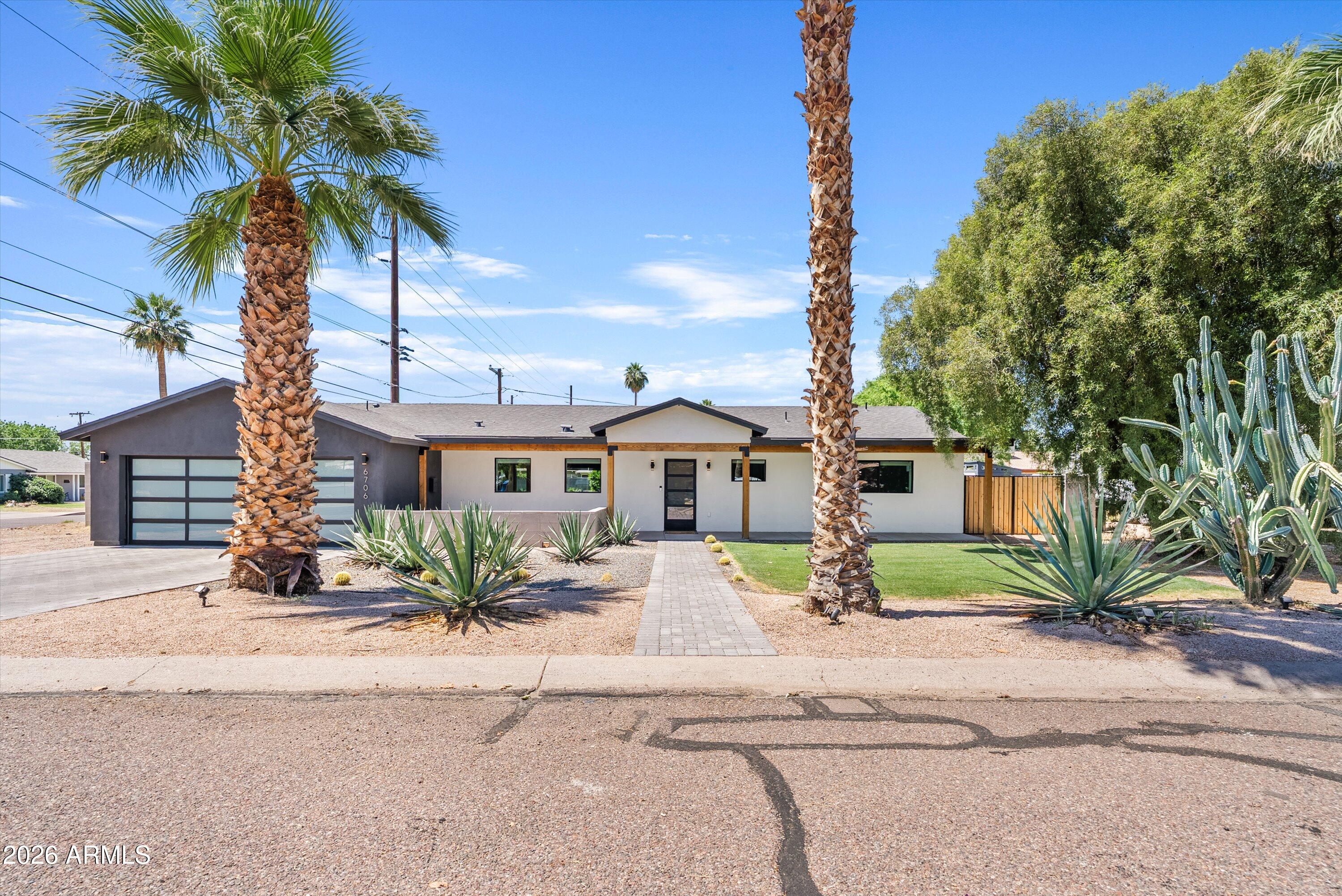 6706 North 12th Way Phoenix, AZ 85014 - Photo 1 of 39 a front view of a house with garden