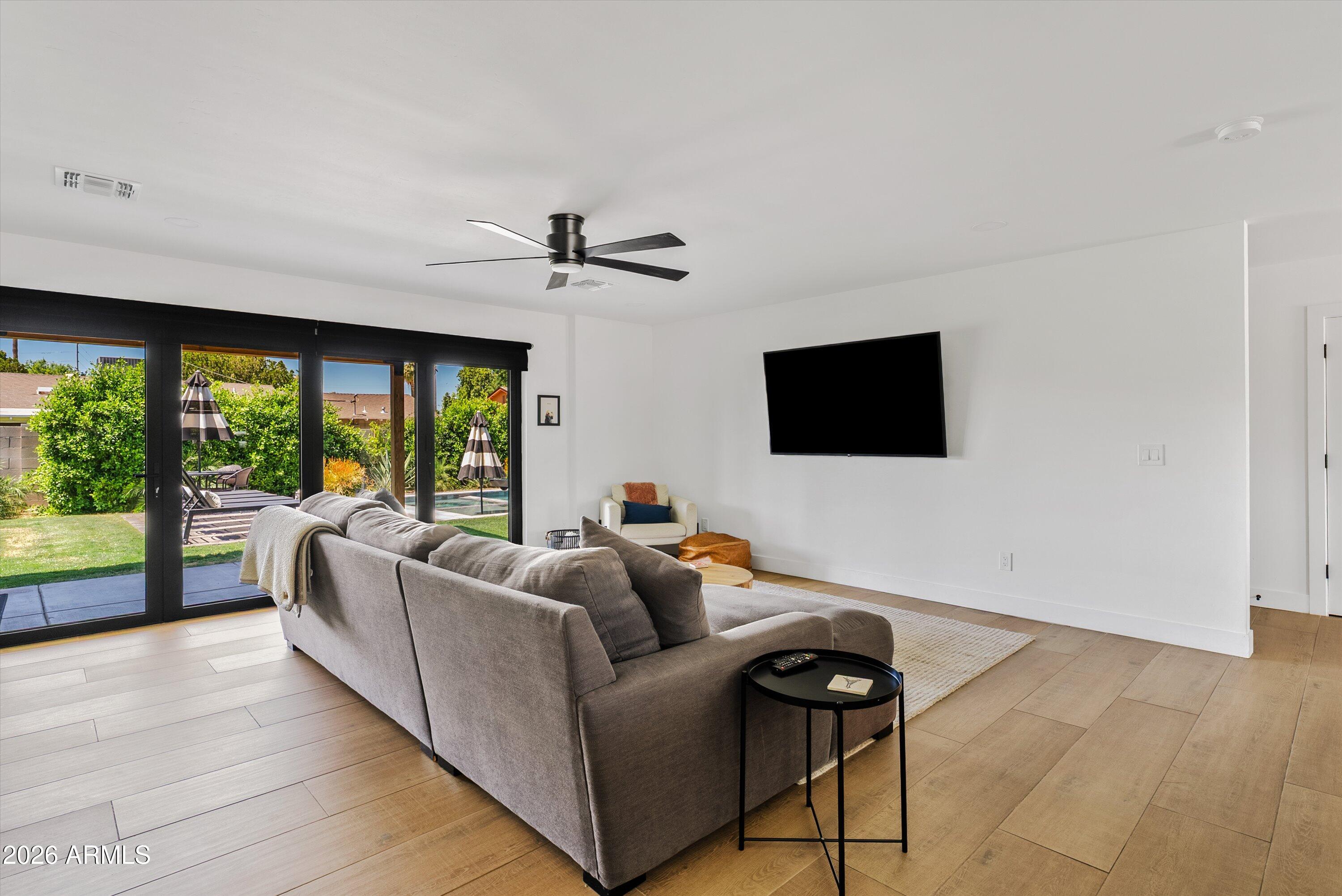 6706 North 12th Way Phoenix, AZ 85014 - Photo 11 of 39 a living room with furniture and a flat screen tv