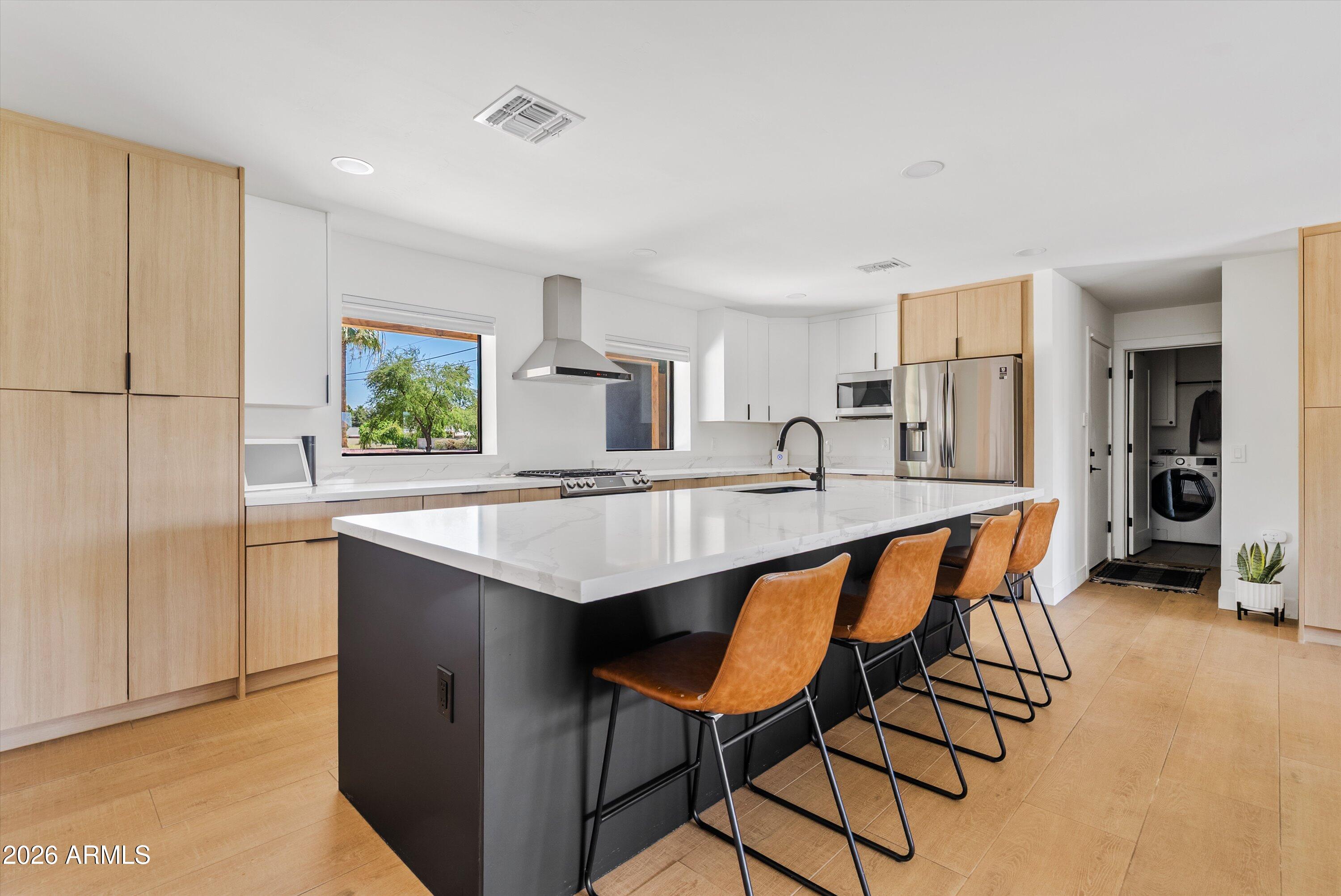 6706 North 12th Way Phoenix, AZ 85014 - Photo 2 of 39 a kitchen with granite countertop a table chairs a sink dishwasher refrigerator and cabinets