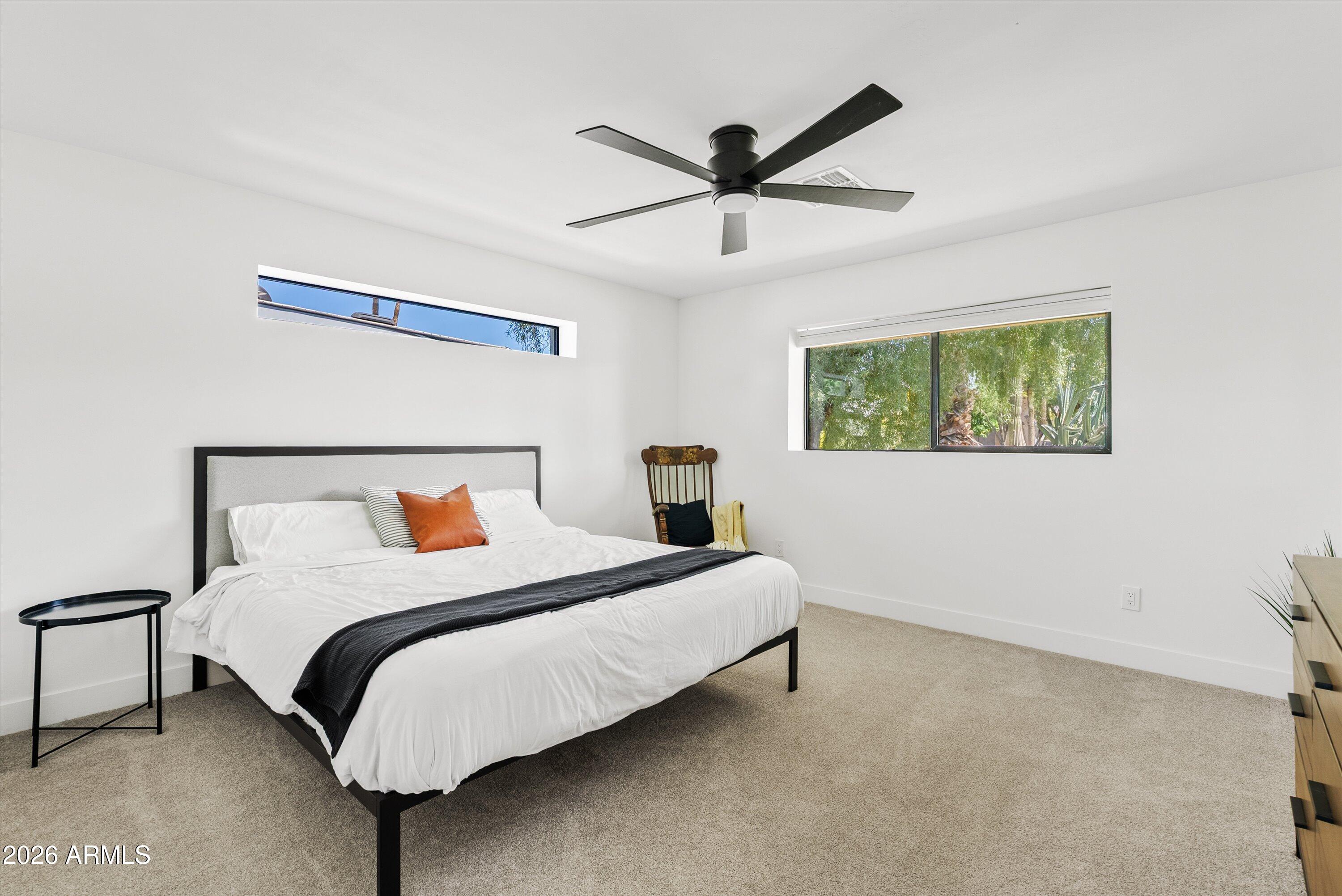 6706 North 12th Way Phoenix, AZ 85014 - Photo 21 of 39 a bedroom with a bed and a painting on the wall