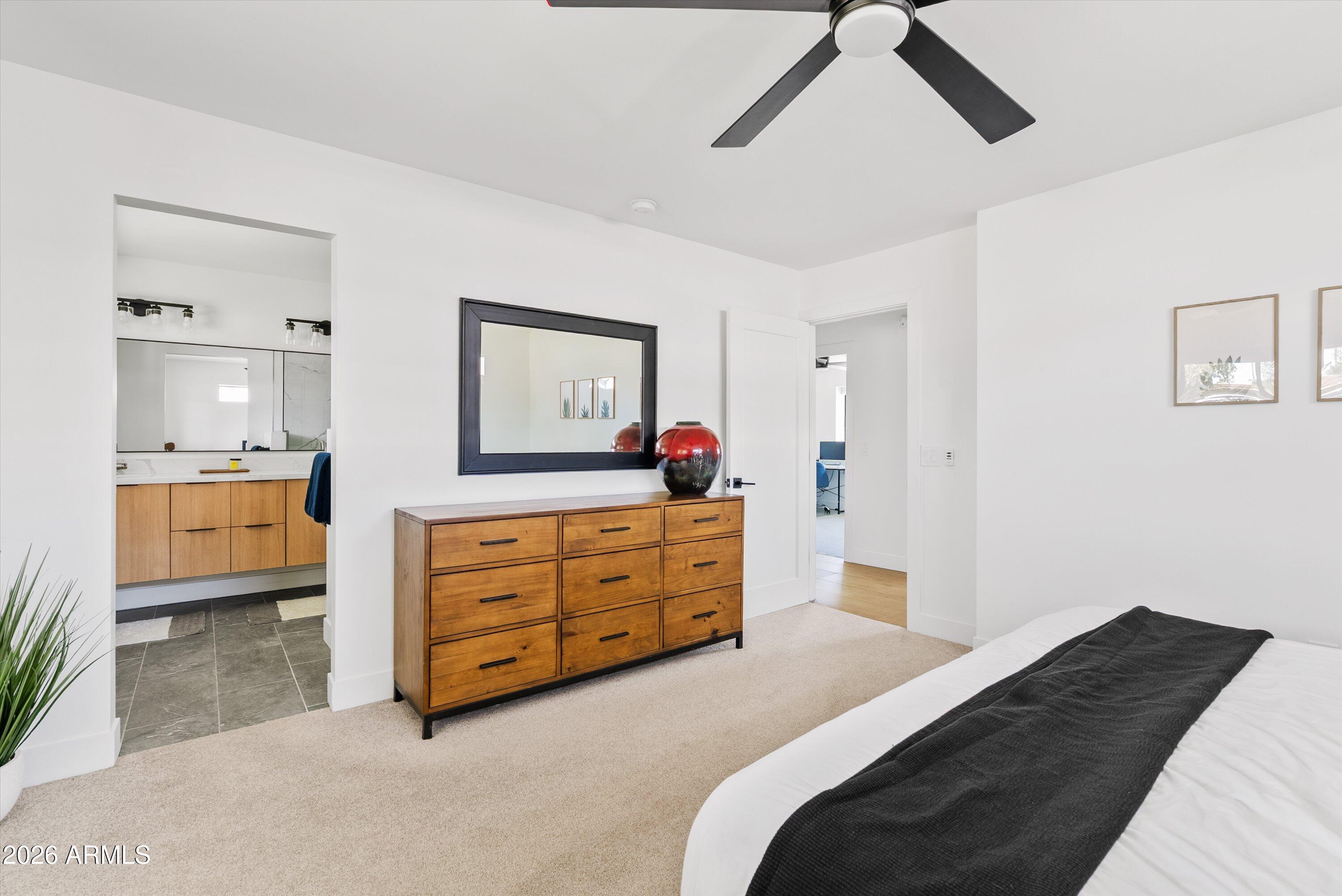 6706 North 12th Way Phoenix, AZ 85014 - Photo 22 of 39 a bedroom with a bed and a dresser