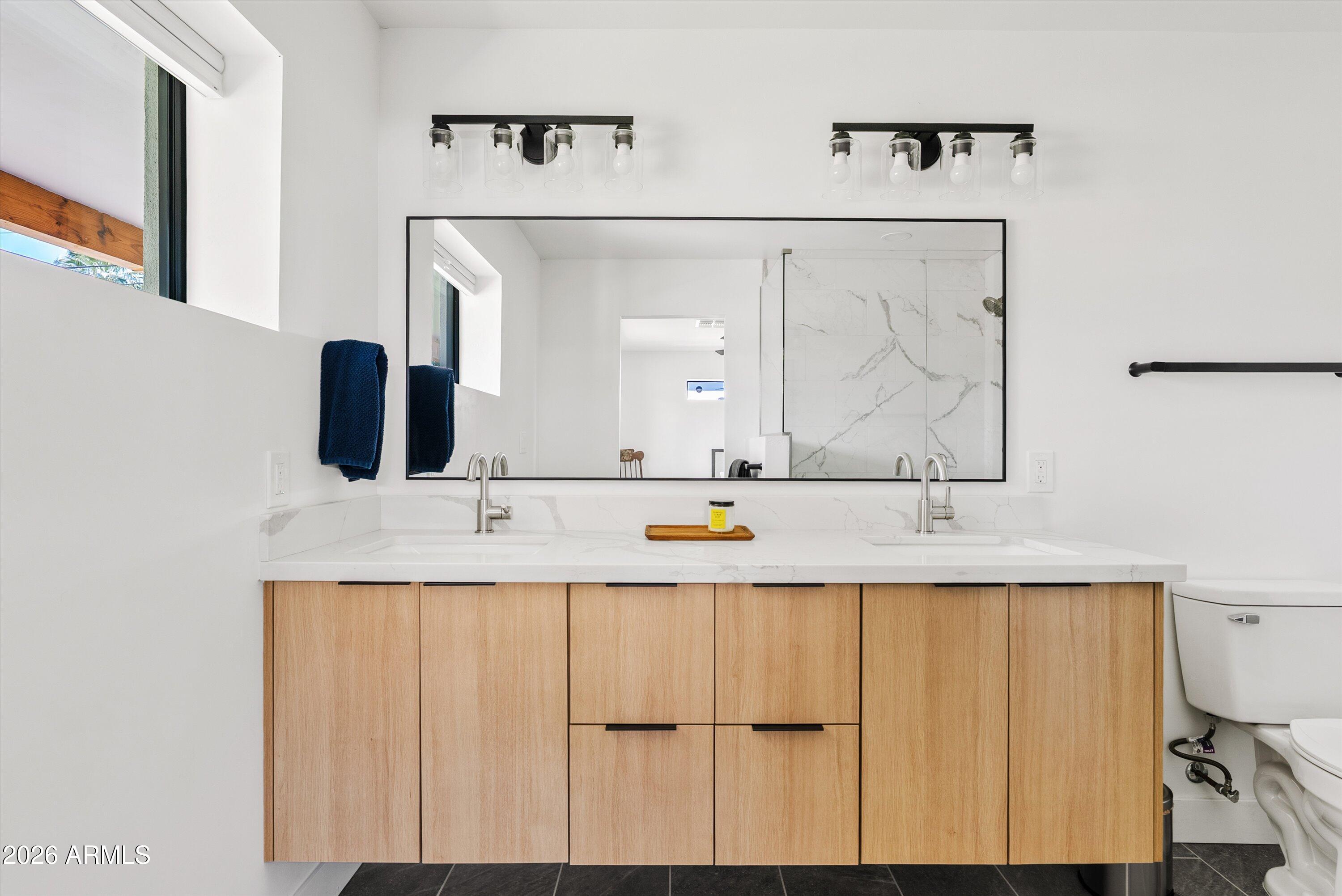 6706 North 12th Way Phoenix, AZ 85014 - Photo 23 of 39 a bathroom with a sink and a mirror
