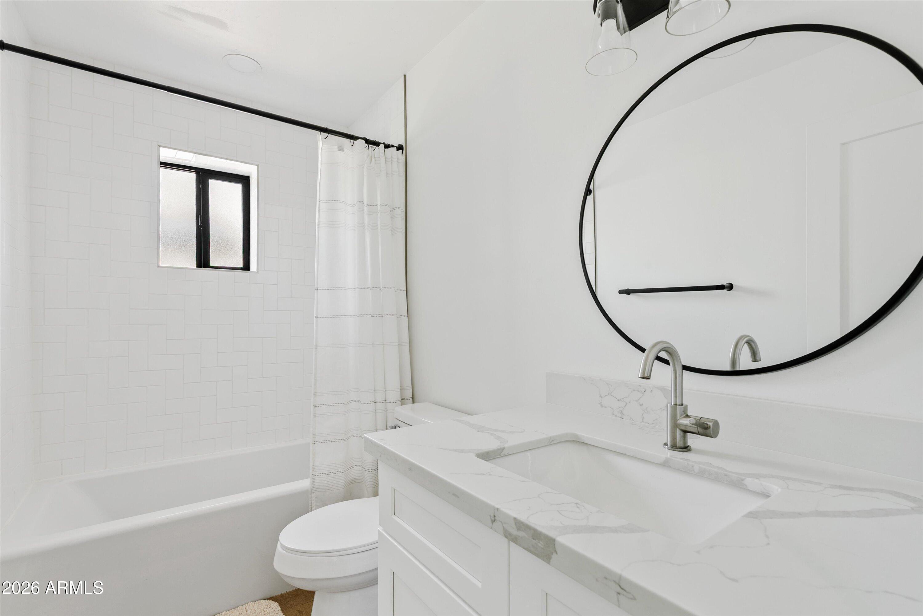 6706 North 12th Way Phoenix, AZ 85014 - Photo 25 of 39 a bathroom with a sink toilet and a mirror