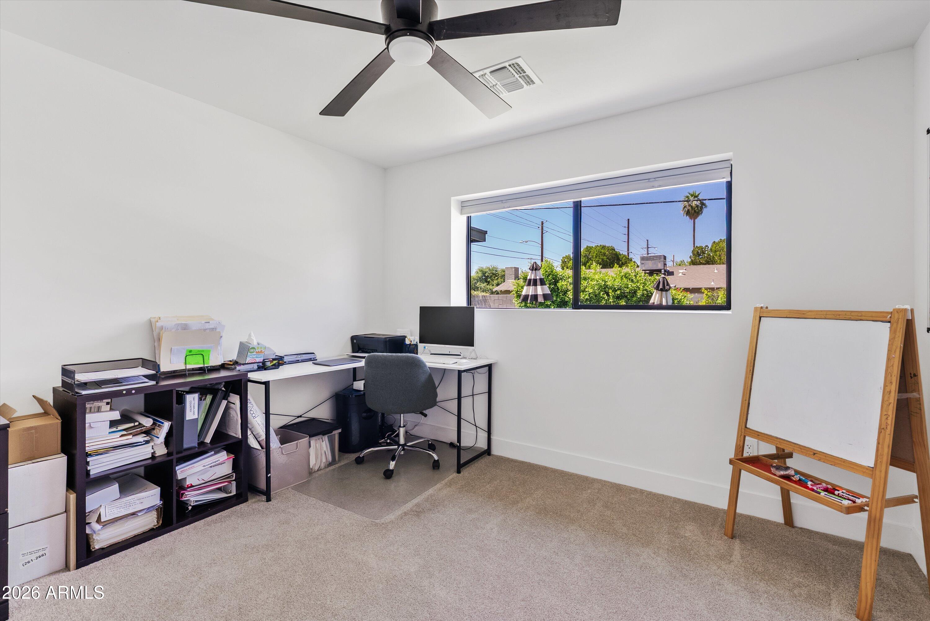 6706 North 12th Way Phoenix, AZ 85014 - Photo 28 of 39 a view of a workspace with furniture and a window