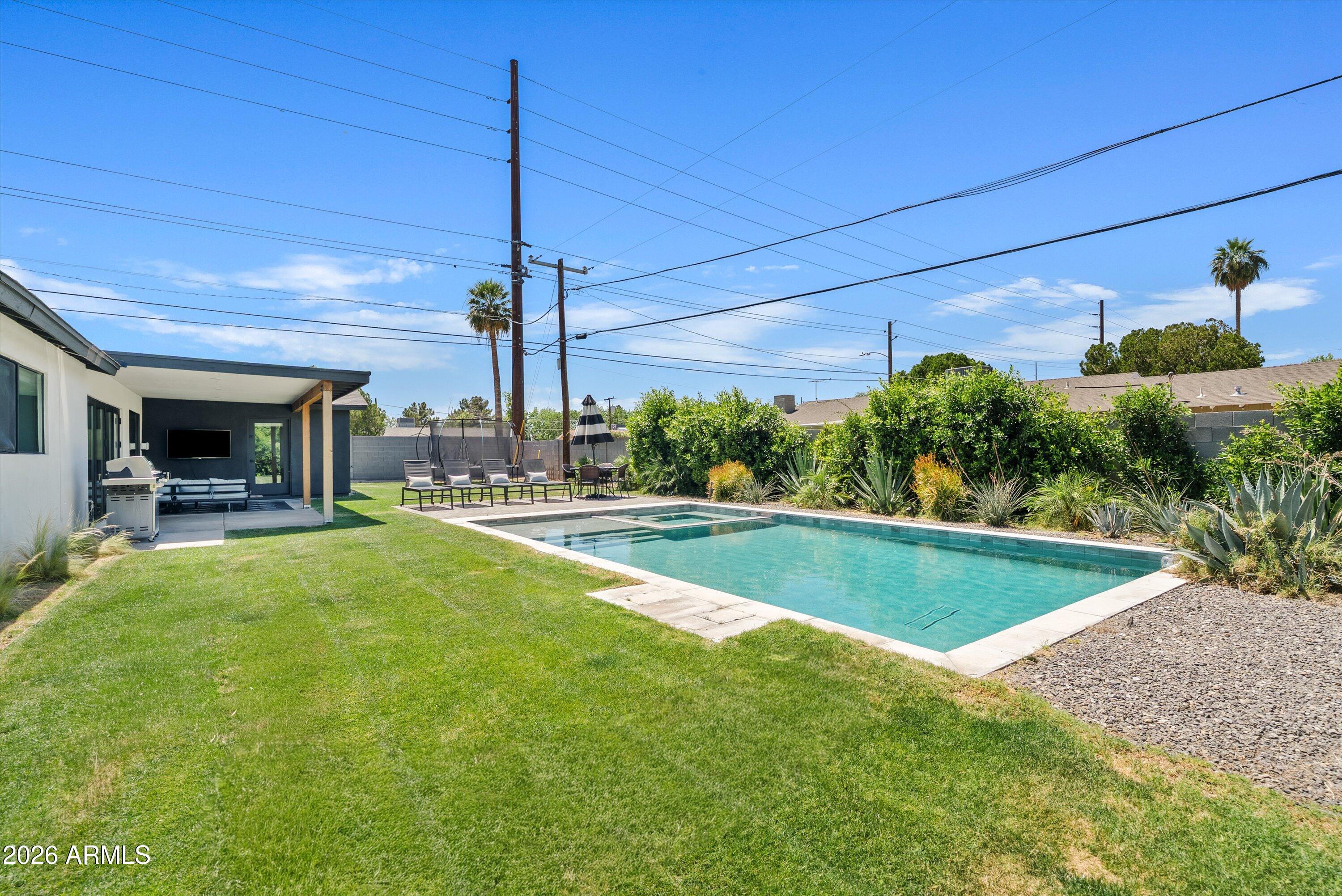 6706 North 12th Way Phoenix, AZ 85014 - Photo 34 of 39 a view of a swimming pool with a patio