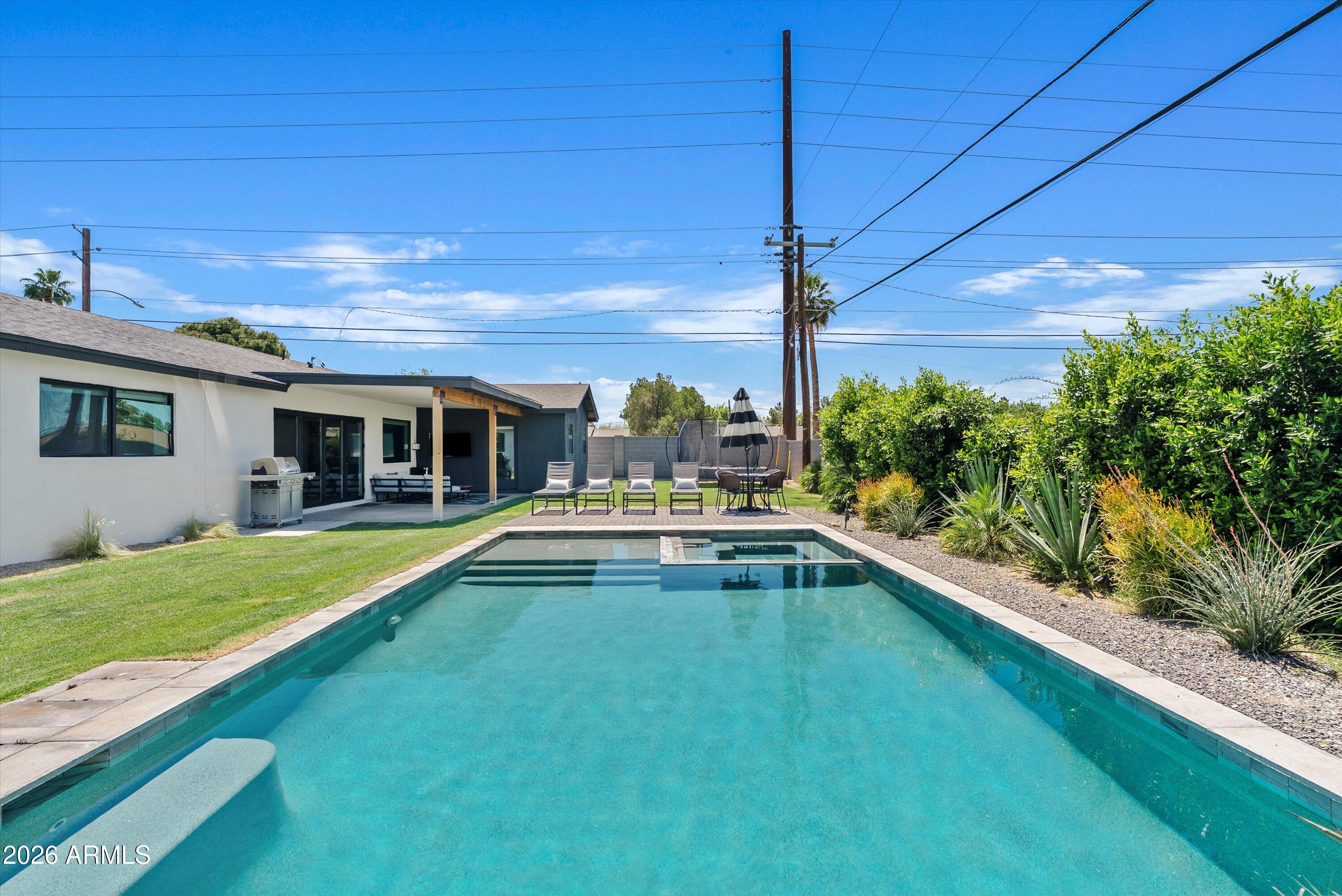 6706 North 12th Way Phoenix, AZ 85014 - Photo 35 of 39 a view of house with swimming pool yard