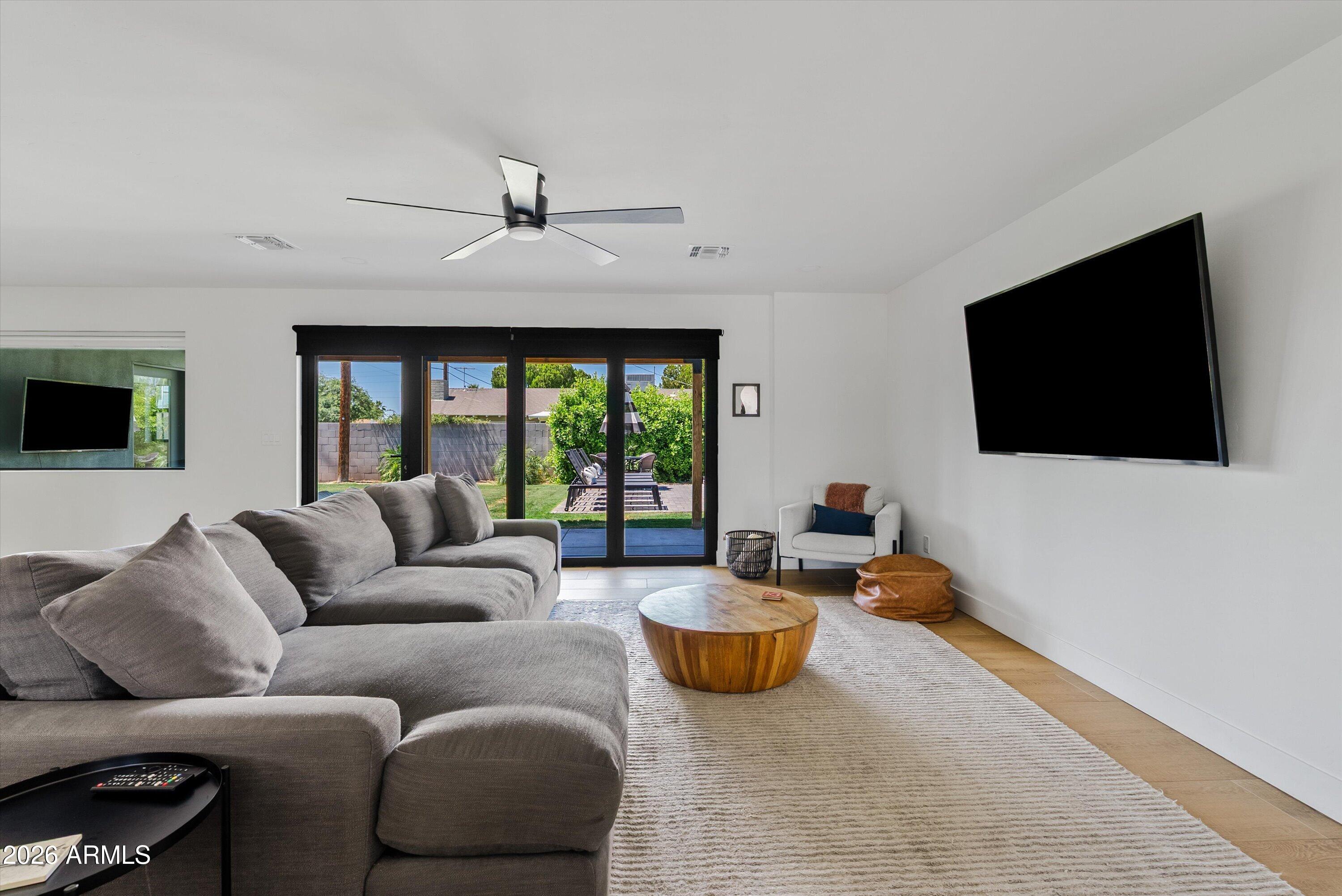 6706 North 12th Way Phoenix, AZ 85014 - Photo 10 of 39 a living room with furniture and a flat screen tv