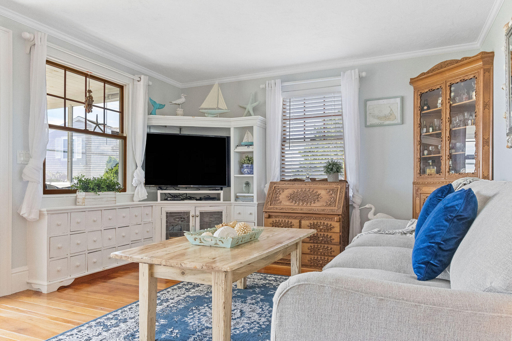 80 Mattakese Road, Unit 7 West Yarmouth, MA 02673 - Photo 16 of 38 a living room with furniture a flat screen tv and a large window
