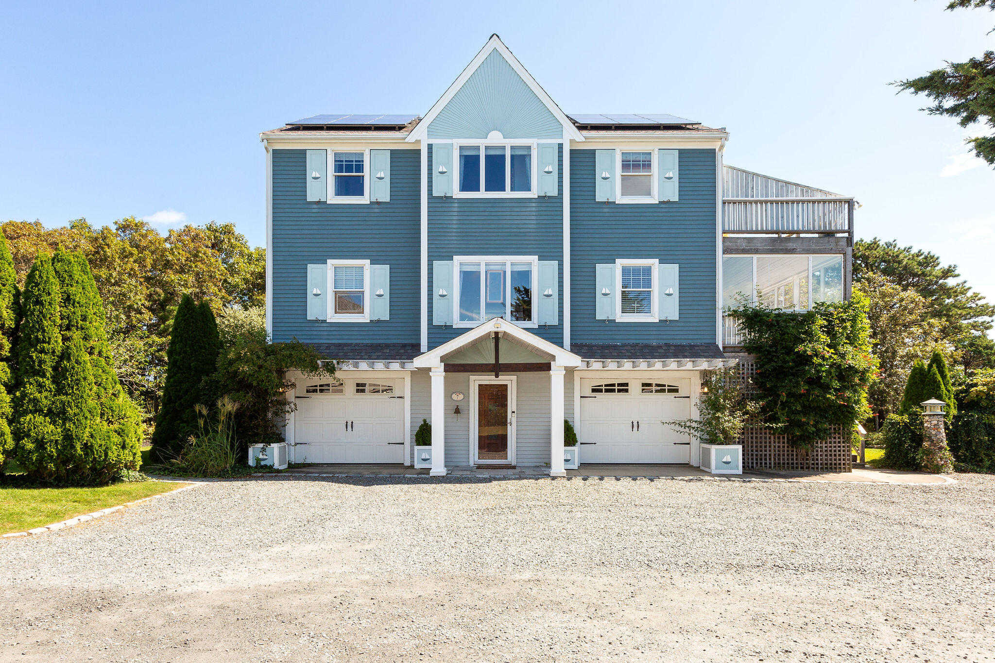 80 Mattakese Road, Unit 7 West Yarmouth, MA 02673 - Photo 2 of 38 a front view of a house with a yard and garage