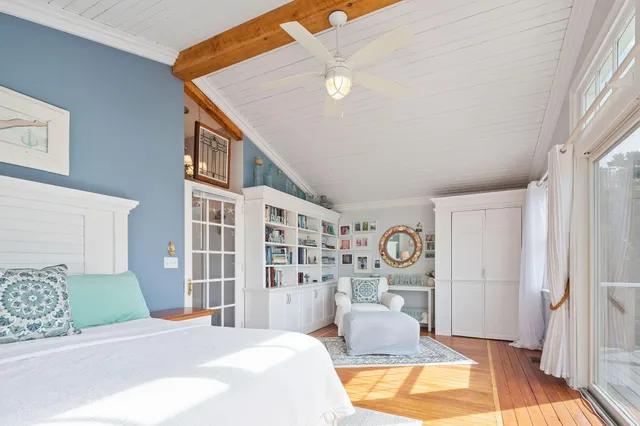 a bedroom with a large bed and a chandelier