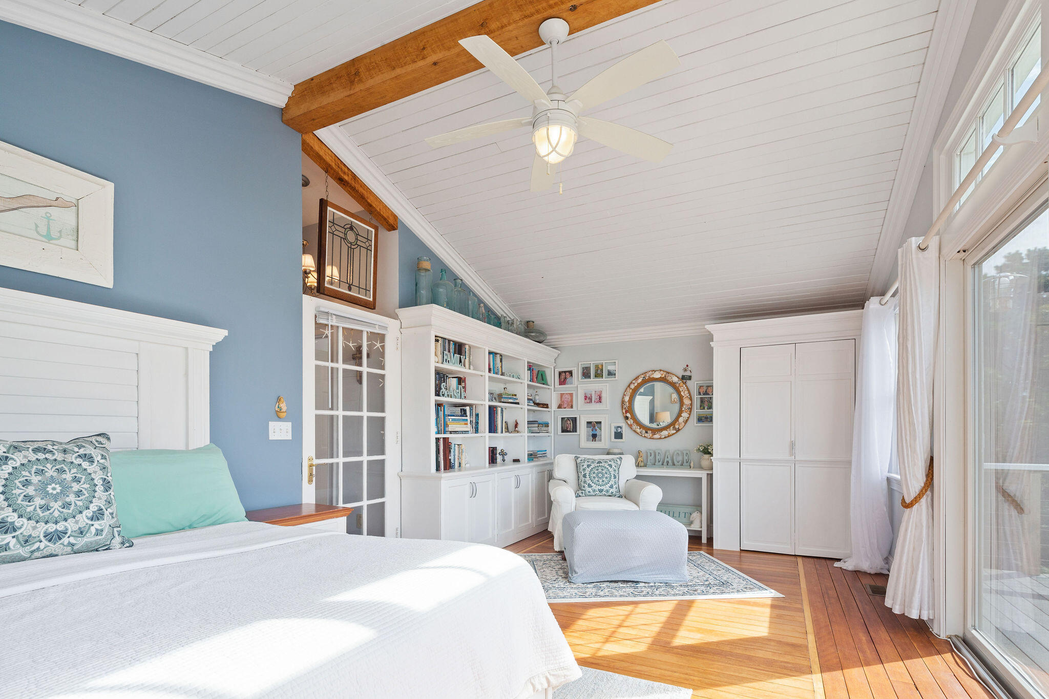 80 Mattakese Road, Unit 7 West Yarmouth, MA 02673 - Photo 25 of 38 a bedroom with a large bed and a chandelier