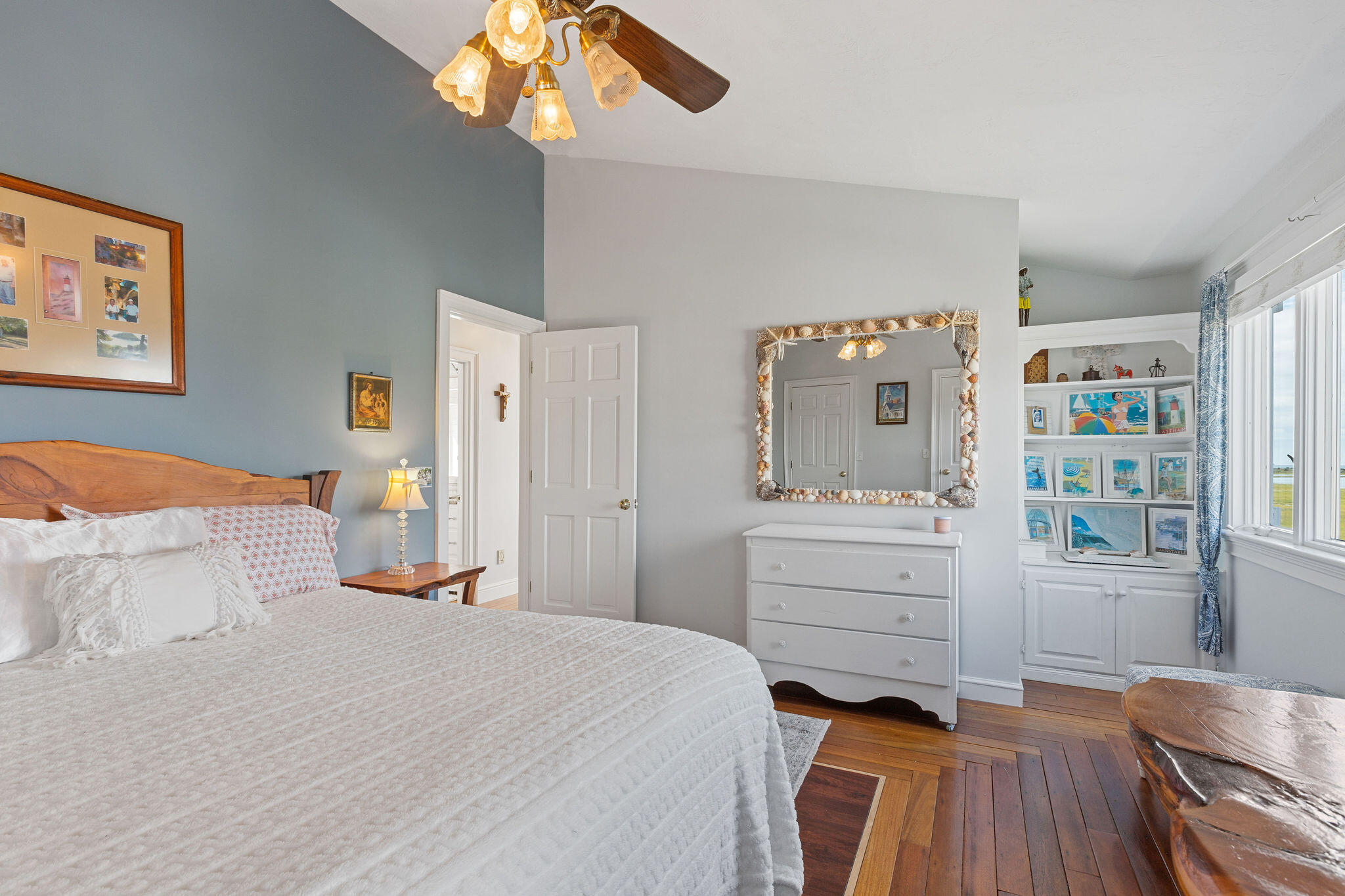 80 Mattakese Road, Unit 7 West Yarmouth, MA 02673 - Photo 33 of 38 a bedroom with a bed and a chandelier