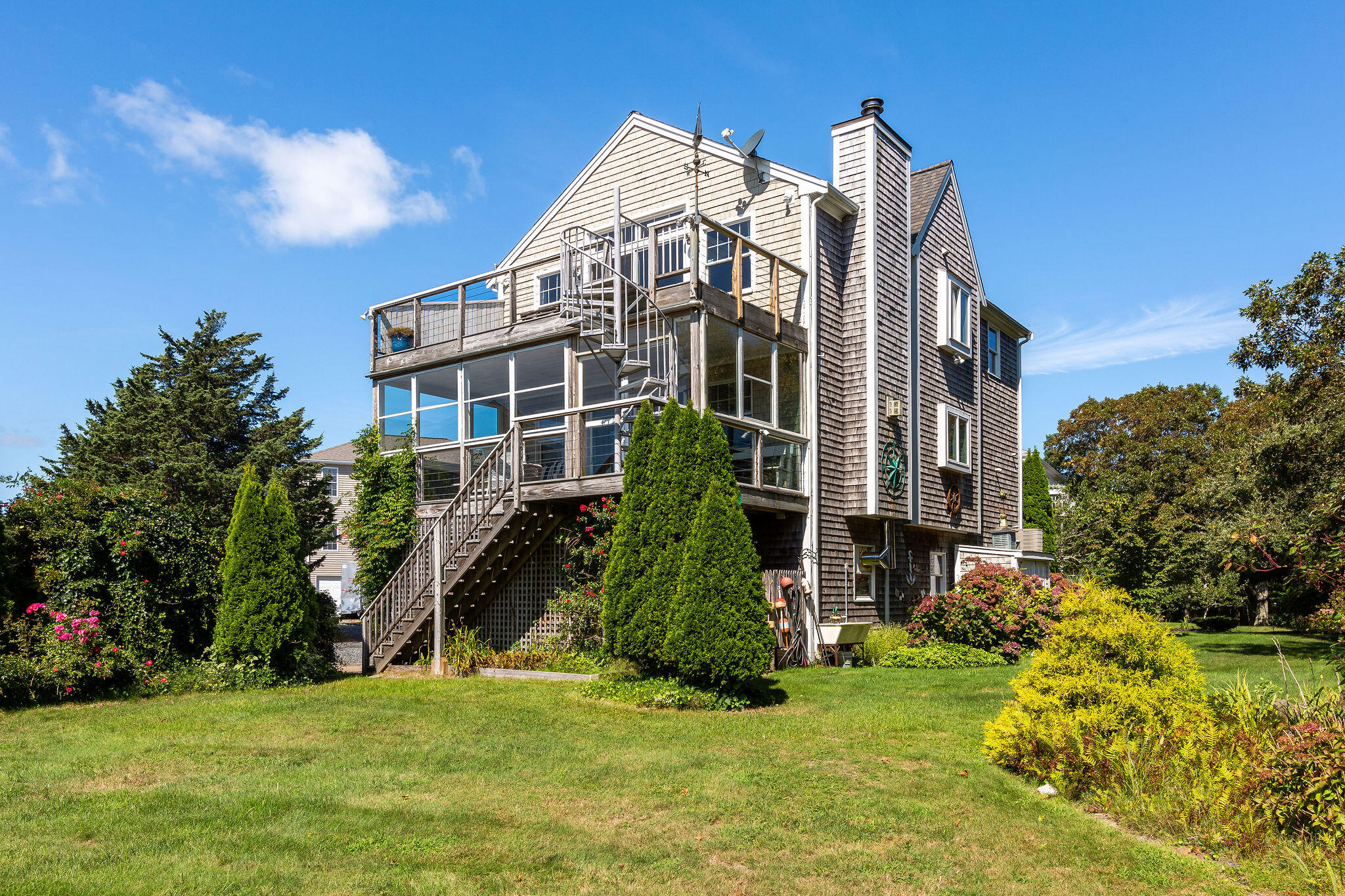 80 Mattakese Road, Unit 7 West Yarmouth, MA 02673 - Photo 35 of 38 a view of a big building with a big yard and large trees