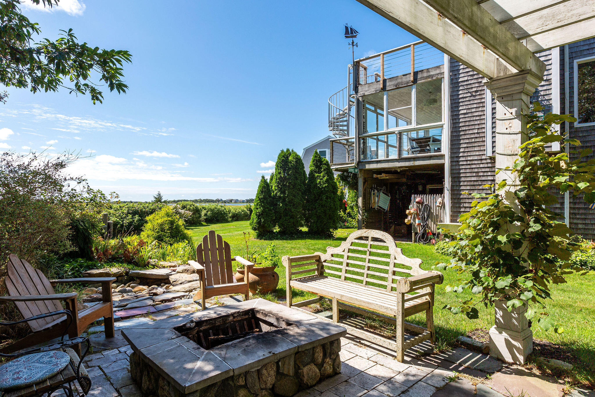 80 Mattakese Road, Unit 7 West Yarmouth, MA 02673 - Photo 36 of 38 a view of a patio with table and chairs and potted plants