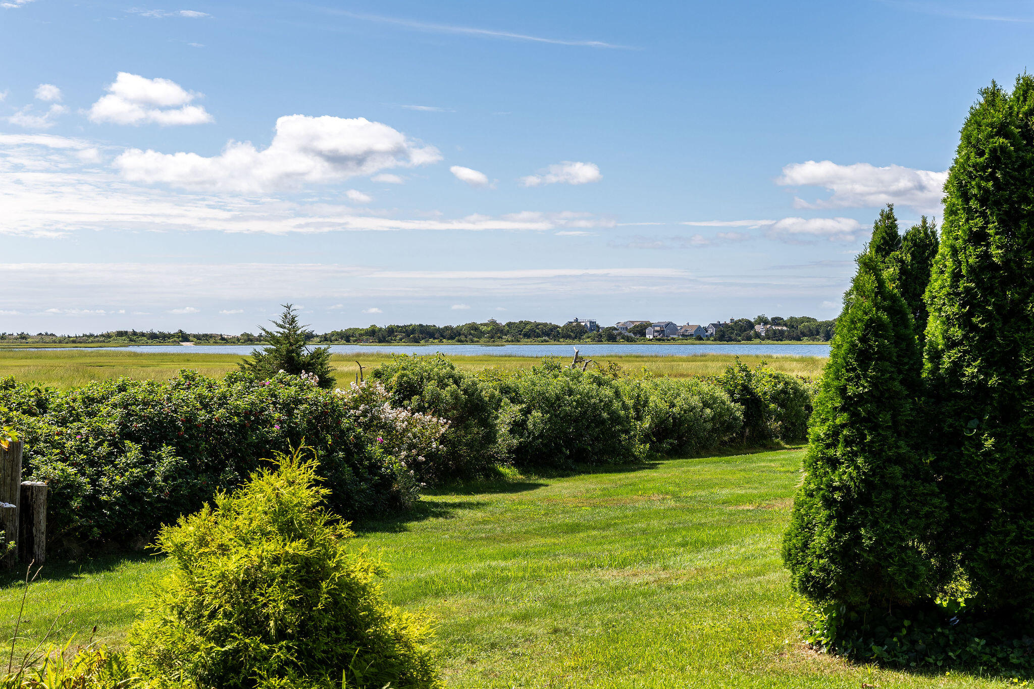 80 Mattakese Road, Unit 7 West Yarmouth, MA 02673 - Photo 5 of 38 a view of a lake with a big yard