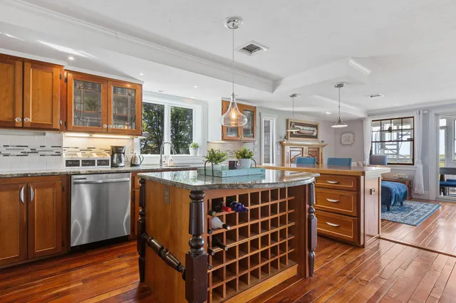 a large kitchen with stainless steel appliances granite countertop a stove and a refrigerator