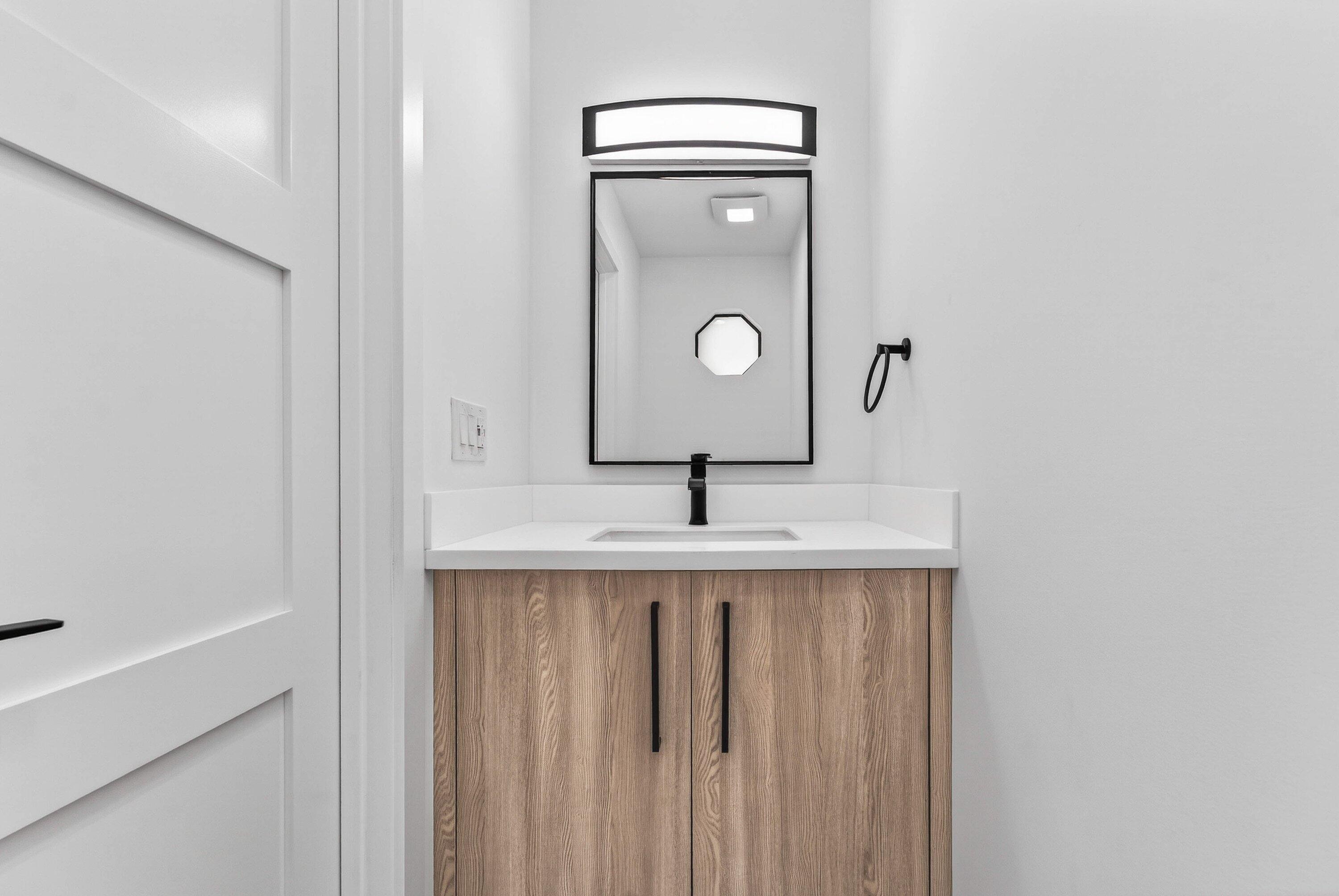 6 Clubhouse Lane Boynton Beach, FL 33436 - Photo 23 of 76 a bathroom with a sink a mirror and vanity