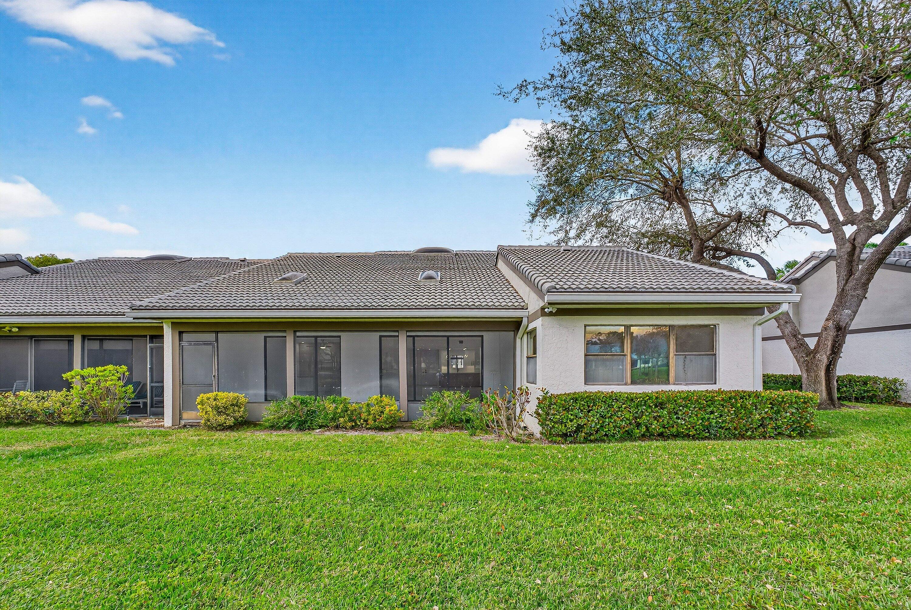 6 Clubhouse Lane Boynton Beach, FL 33436 - Photo 59 of 76 a front view of house with yard and green space