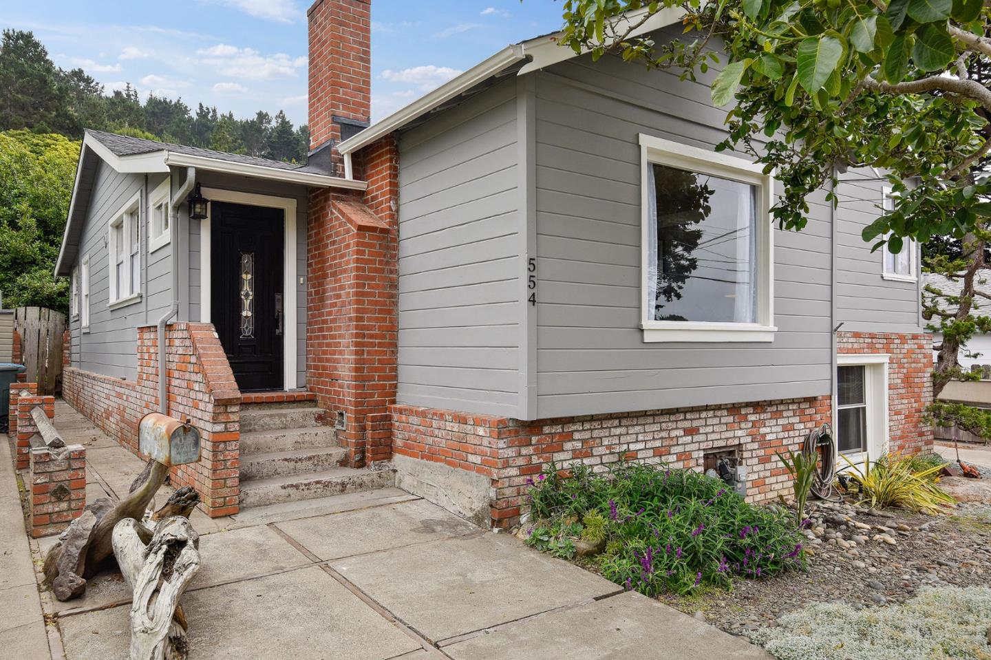 554 Brighton Road Pacifica, CA 94044 - Photo 1 of 50 a front view of a house with garden