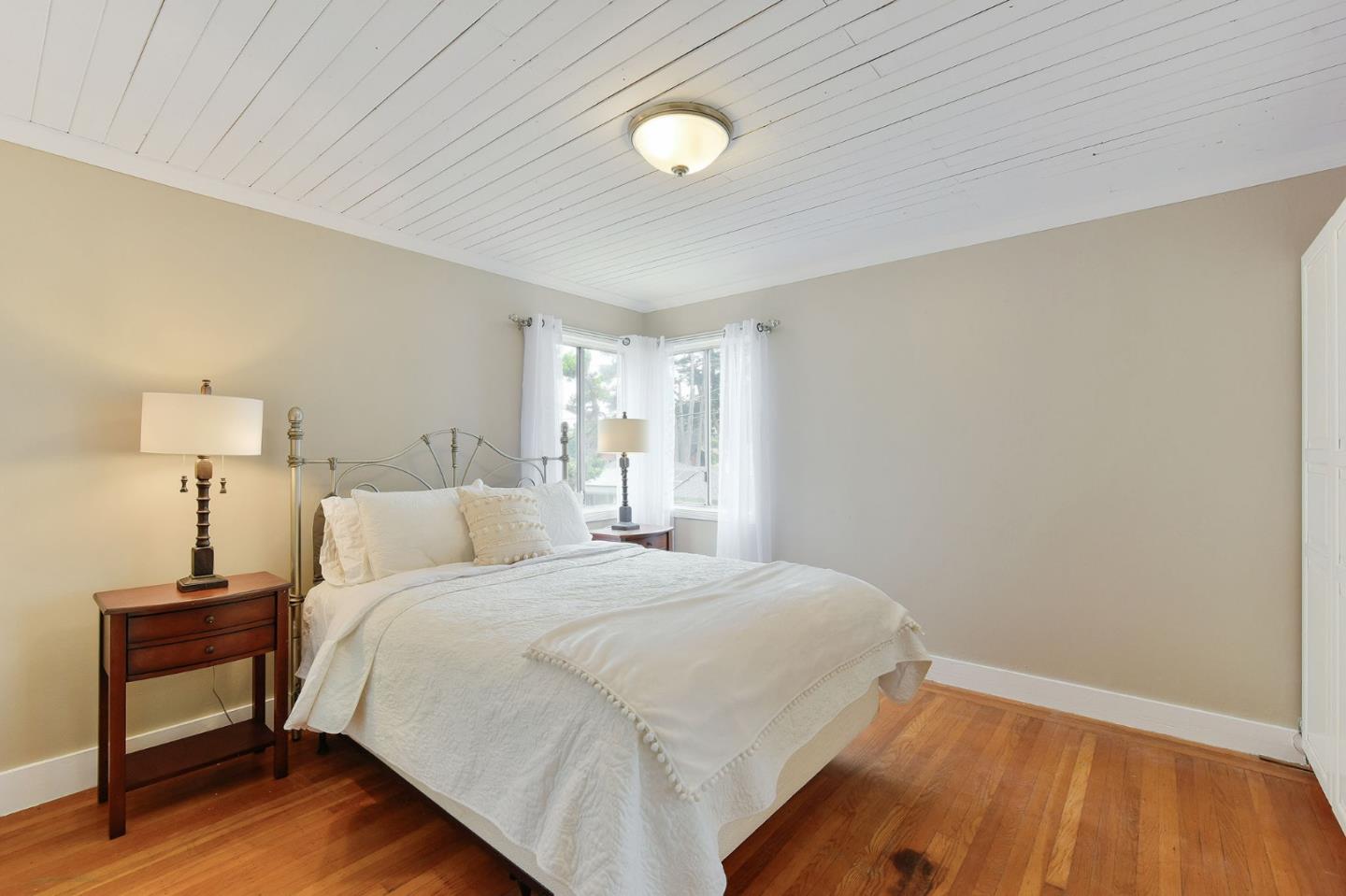 554 Brighton Road Pacifica, CA 94044 - Photo 16 of 50 a bedroom with a bed and a lamp