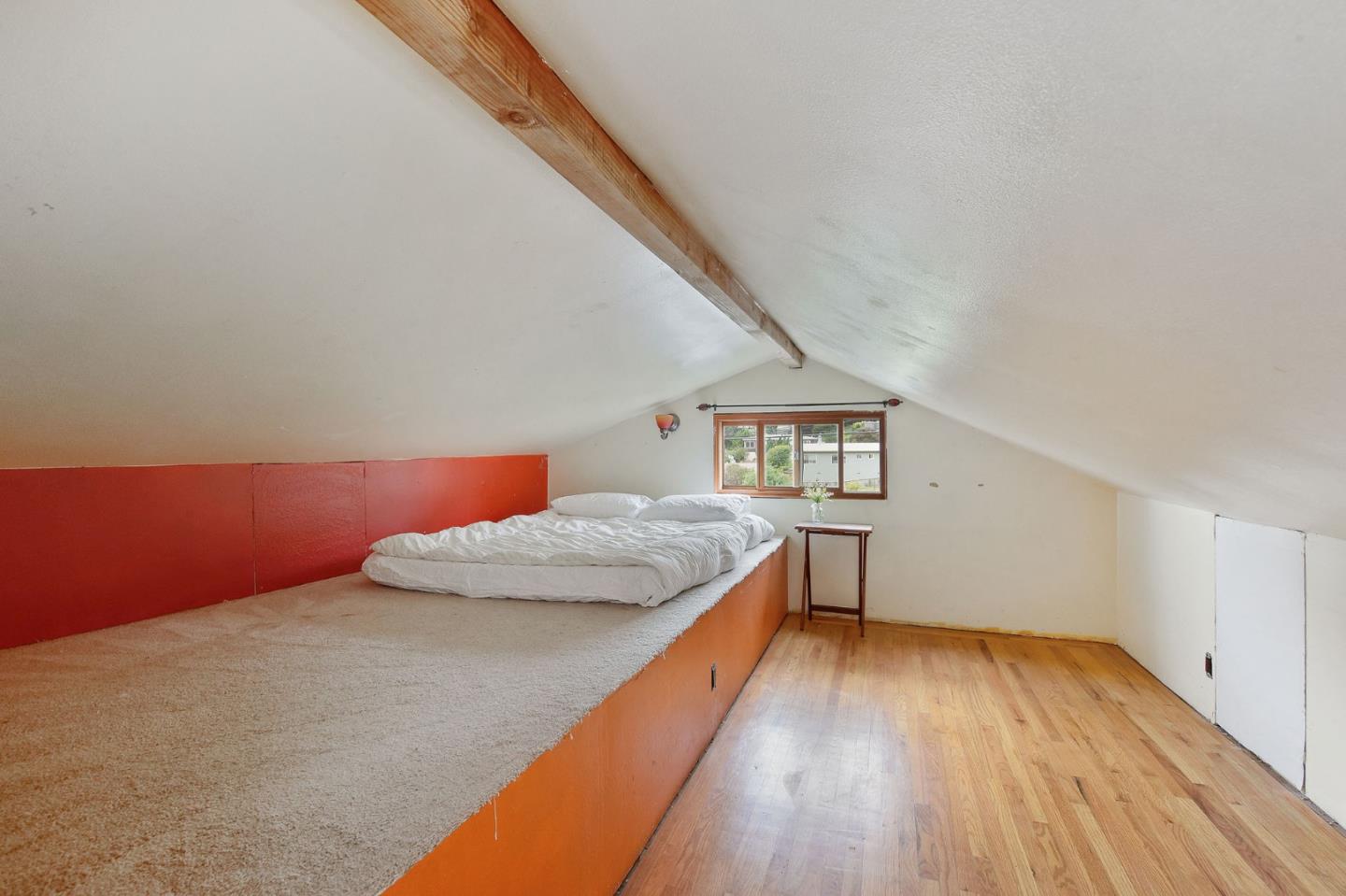 554 Brighton Road Pacifica, CA 94044 - Photo 21 of 50 a bedroom with a bed and a wooden floor