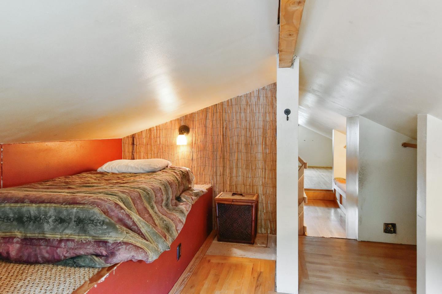 554 Brighton Road Pacifica, CA 94044 - Photo 23 of 50 a bedroom with a bed and wooden floor