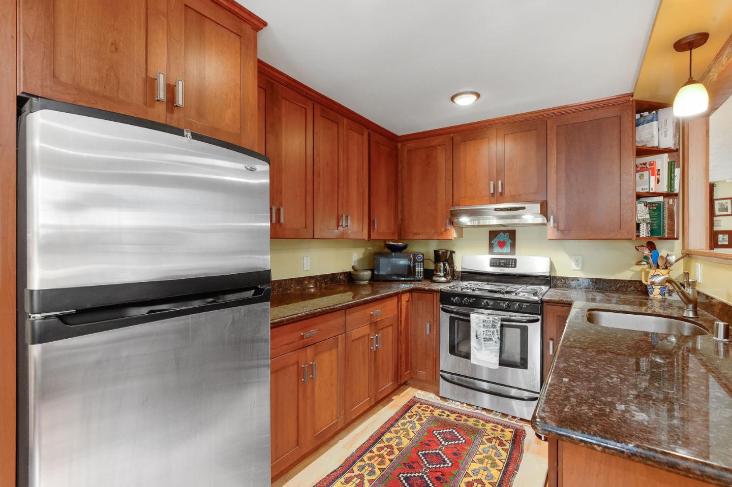 554 Brighton Road Pacifica, CA 94044 - Photo 27 of 50 a kitchen with granite countertop a sink stove and cabinets