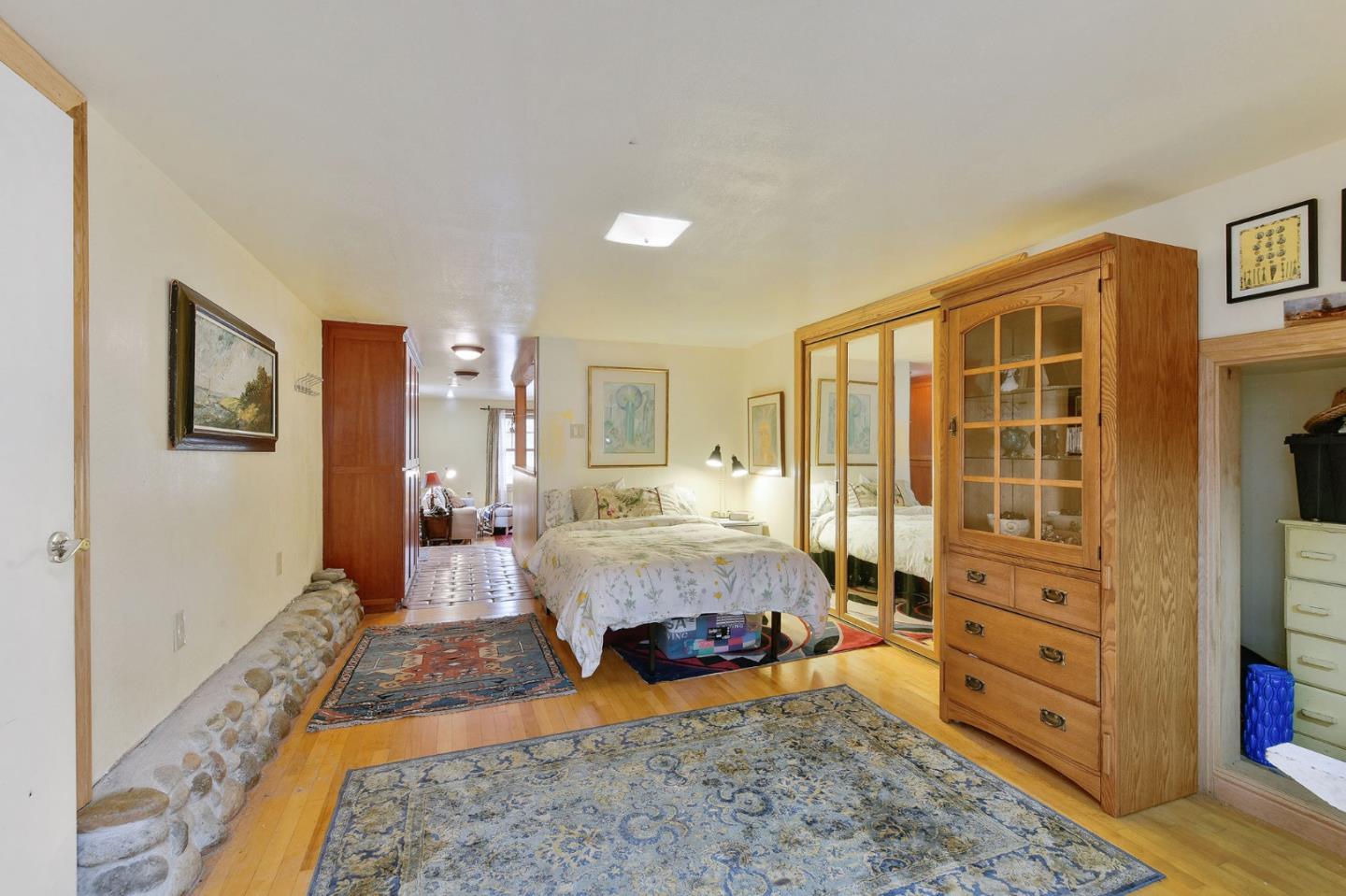 554 Brighton Road Pacifica, CA 94044 - Photo 30 of 50 a spacious bedroom with a bed and wooden floor