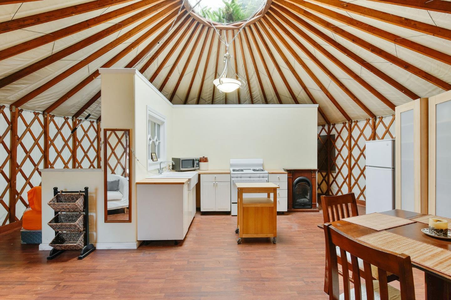 554 Brighton Road Pacifica, CA 94044 - Photo 38 of 50 a workspace with wooden floor and a chandelier