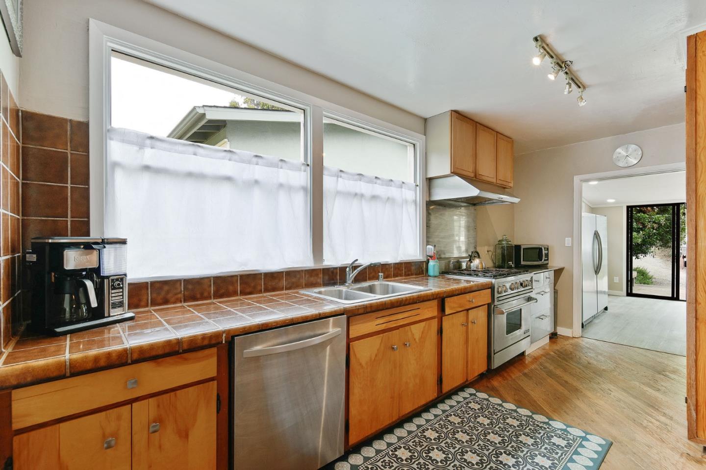 554 Brighton Road Pacifica, CA 94044 - Photo 8 of 50 a kitchen with a sink stove and cabinets