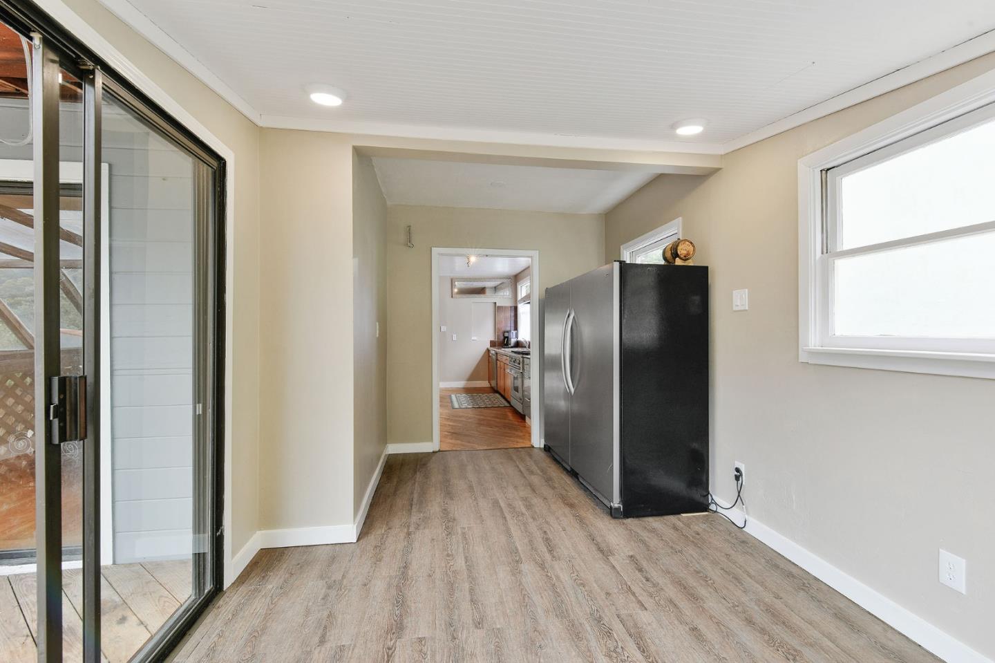 554 Brighton Road Pacifica, CA 94044 - Photo 10 of 50 a view of a refrigerator in kitchen and wooden floor