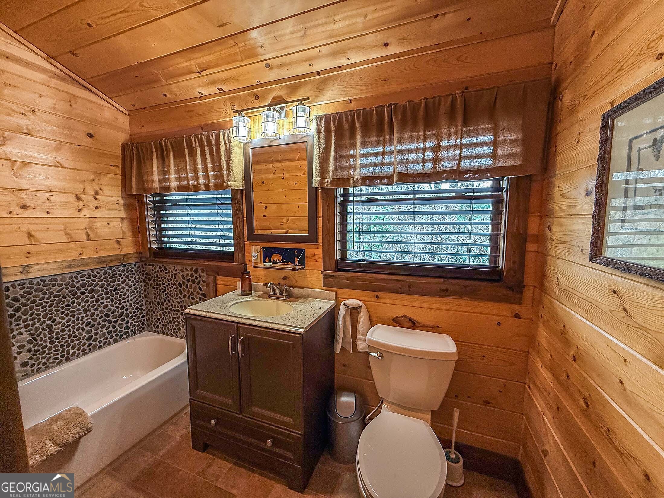 513 Coleman Heights Lane Rabun Gap, GA 30568 - Photo 15 of 36 a bathroom with a sink a toilet and bathtub