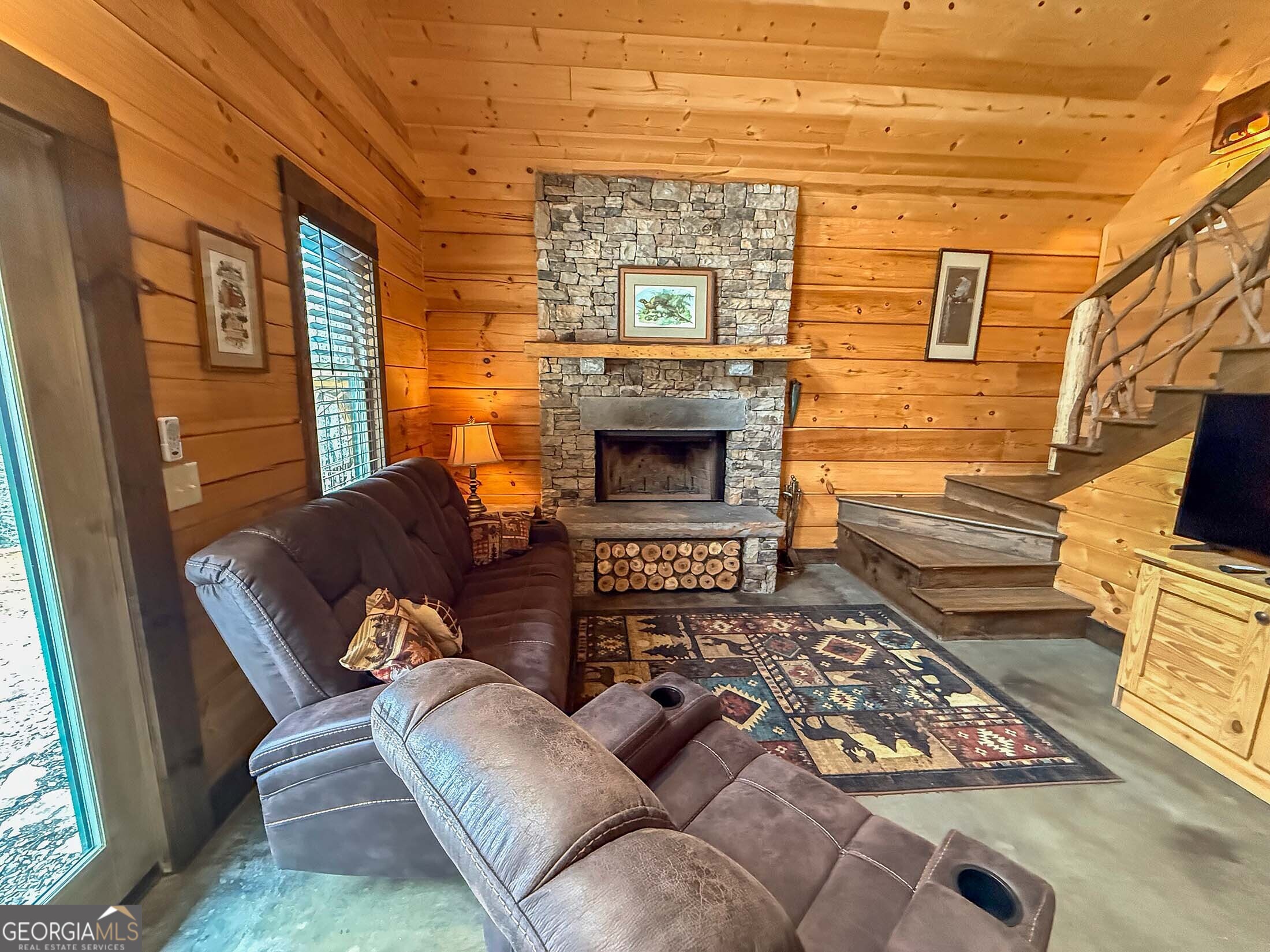 513 Coleman Heights Lane Rabun Gap, GA 30568 - Photo 19 of 36 a living room with furniture rug and a fireplace
