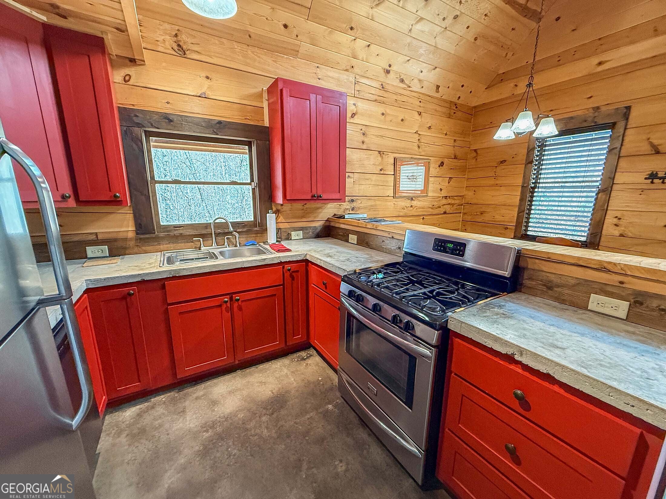 513 Coleman Heights Lane Rabun Gap, GA 30568 - Photo 23 of 36 a kitchen with stainless steel appliances granite countertop a stove a sink and a microwave